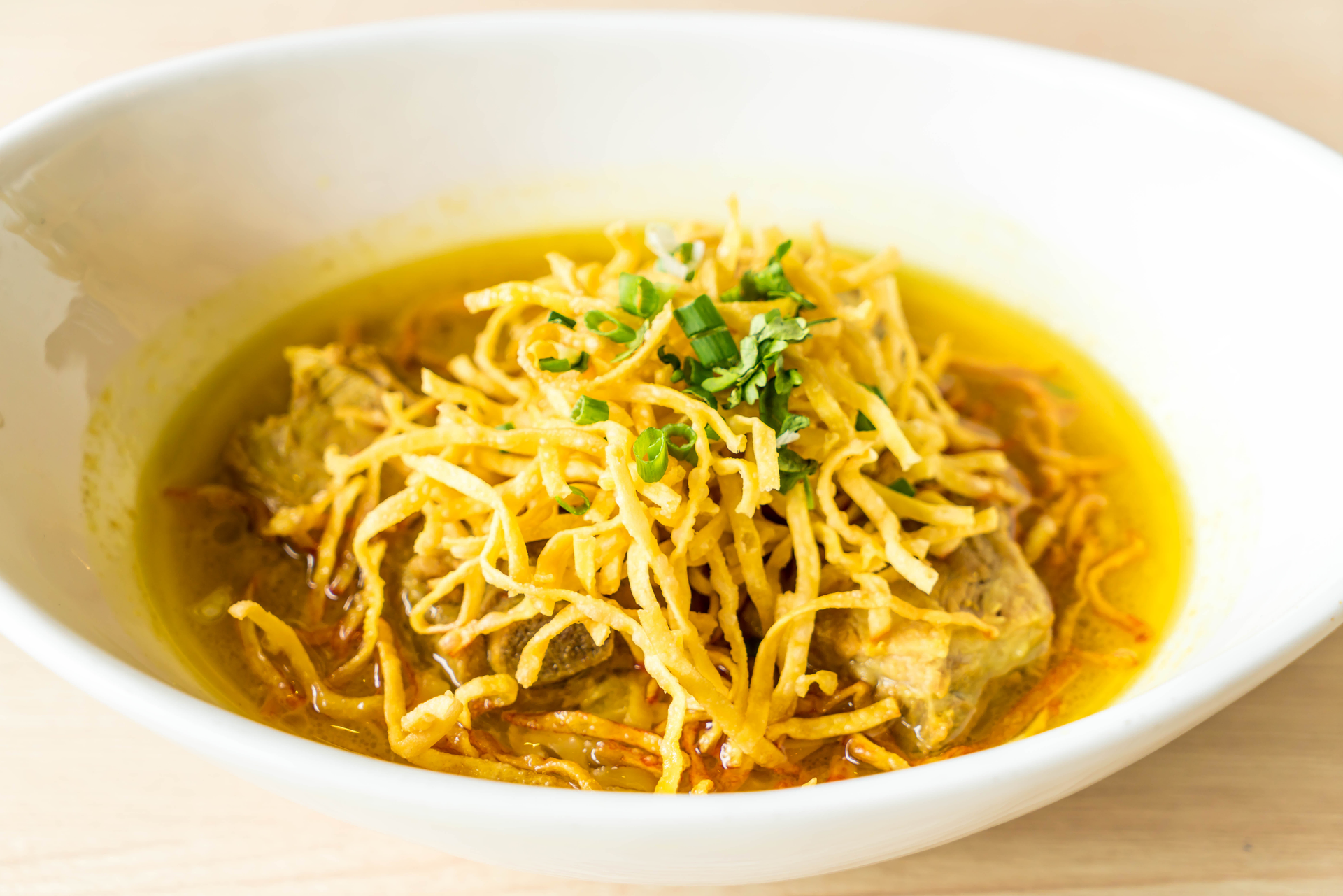 Overhead flat-lay of all ingredients for Malaysian Curry Mee with Yellow Noodles and Tofu laid out on a kitchen surface.