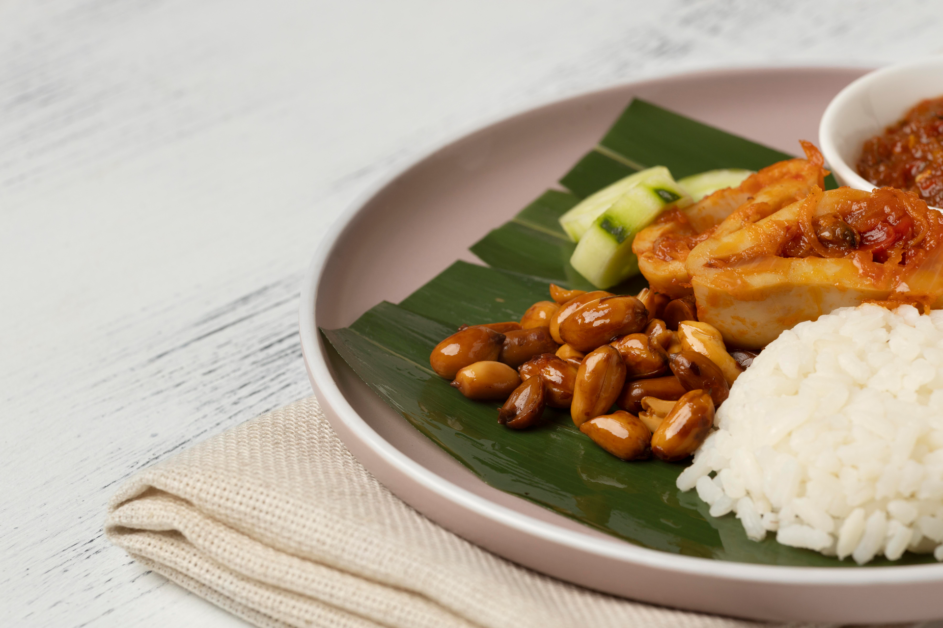 Overhead flat-lay of all ingredients for Malaysian Nasi Lemak with Coconut Rice and Sambal Ikan Bilis laid out on a kitchen surface.
