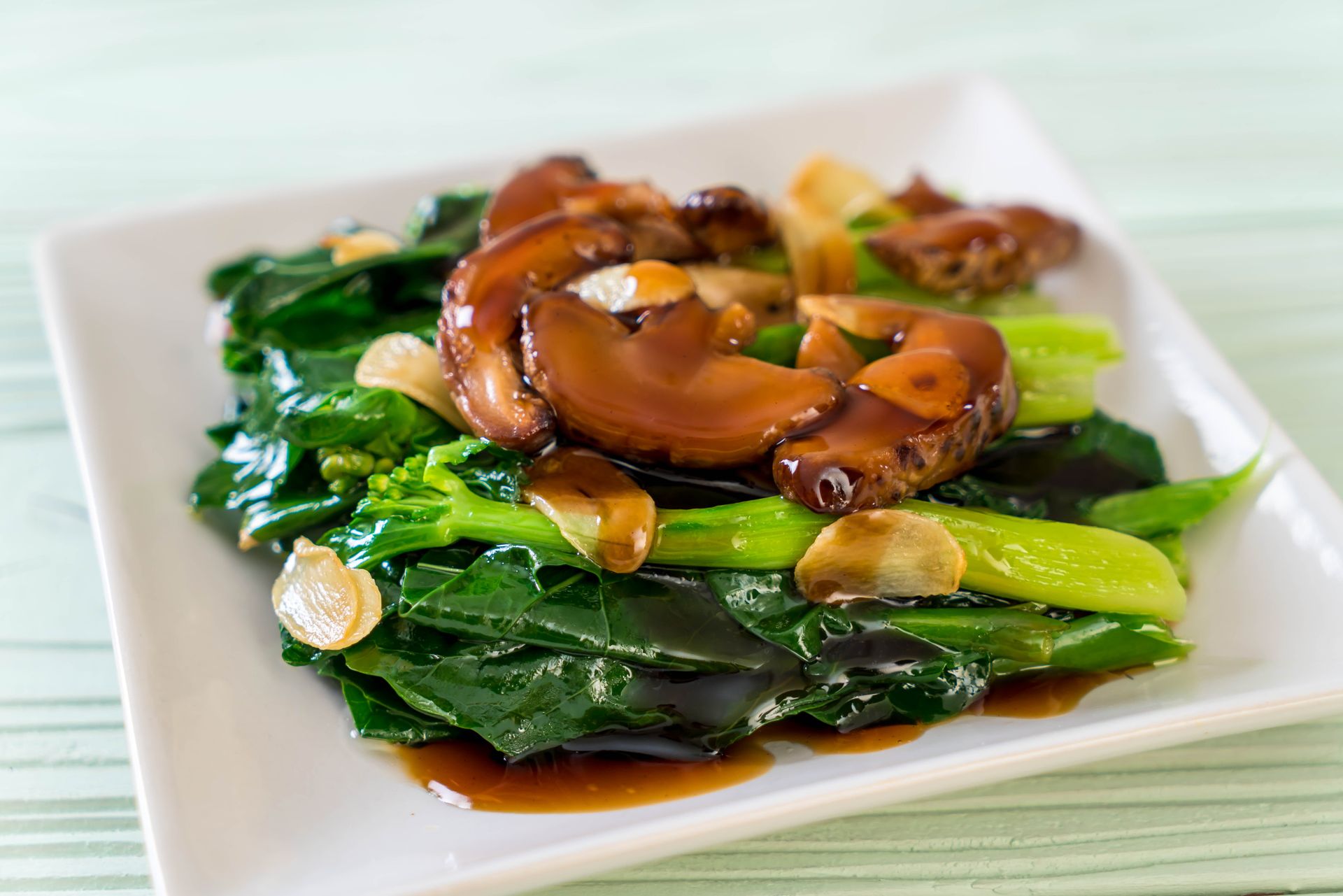 Overhead flat-lay of all ingredients for Mandarin Caramel Pork with Crispy Water Spinach laid out on a kitchen surface.