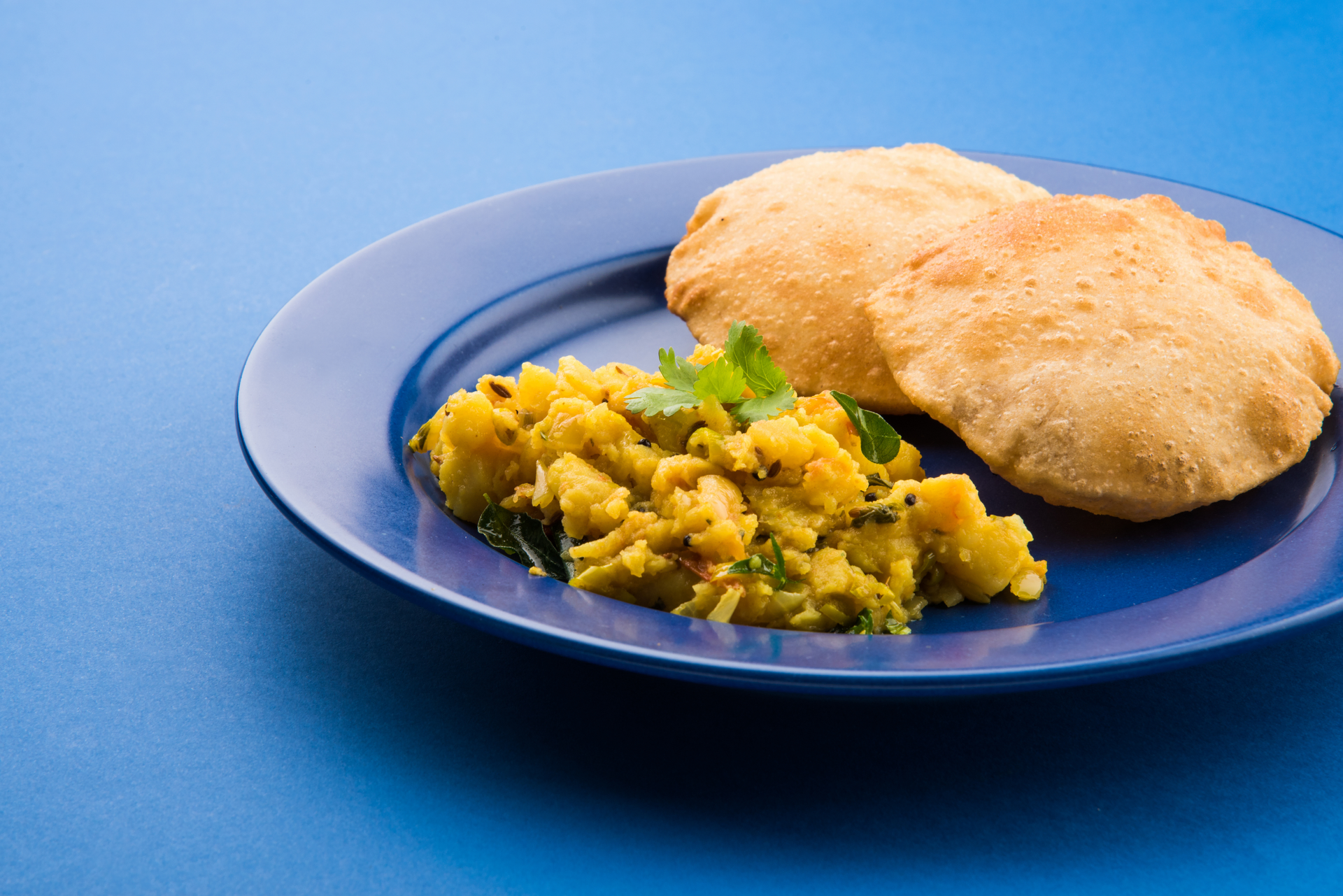Overhead flat-lay of all ingredients for Mauritian Dholl Puri with Curried Split Peas laid out on a kitchen surface.