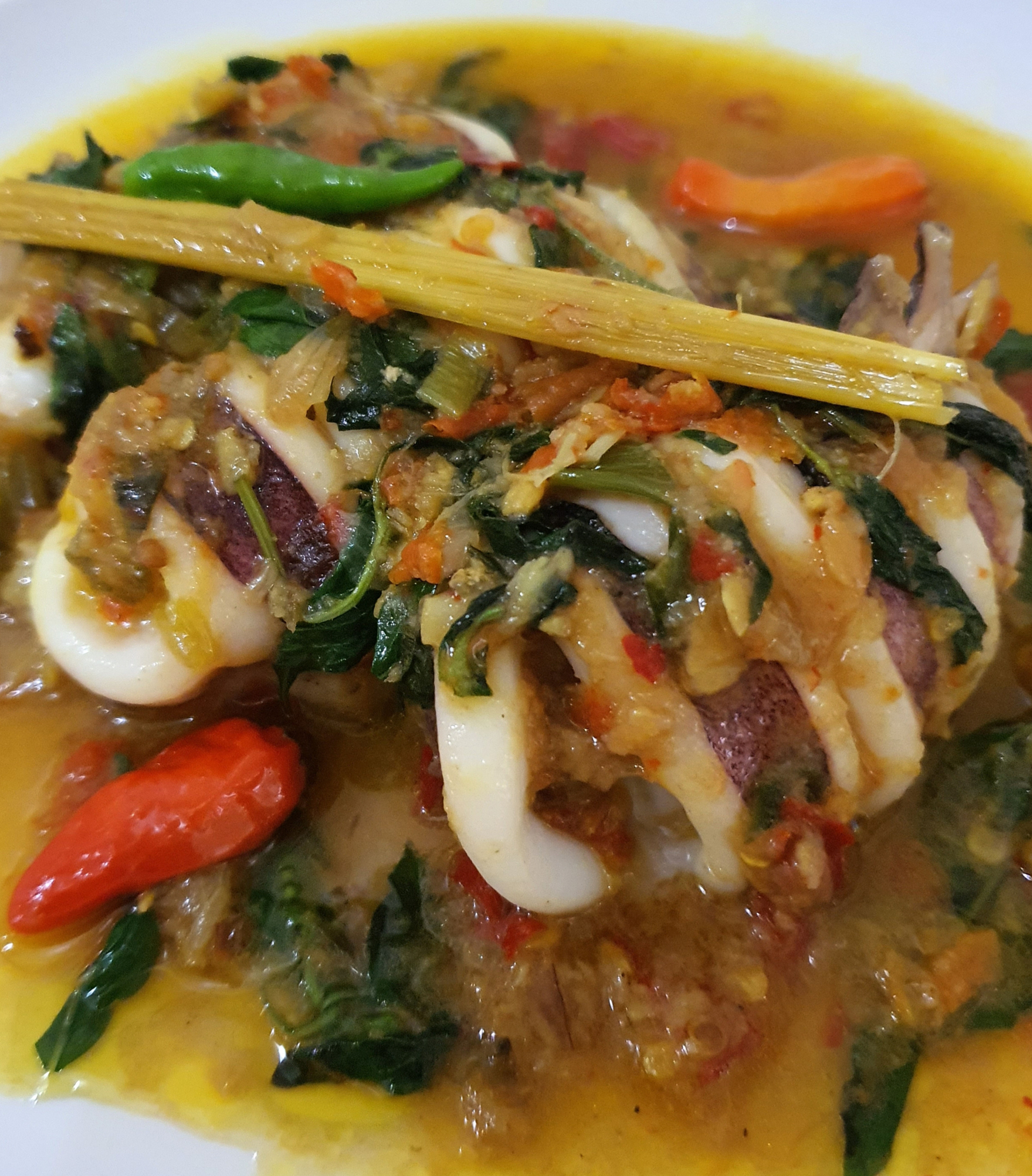 Overhead flat-lay of all ingredients for Mauritian Octopus Curry with Turmeric and Coconut laid out on a kitchen surface.
