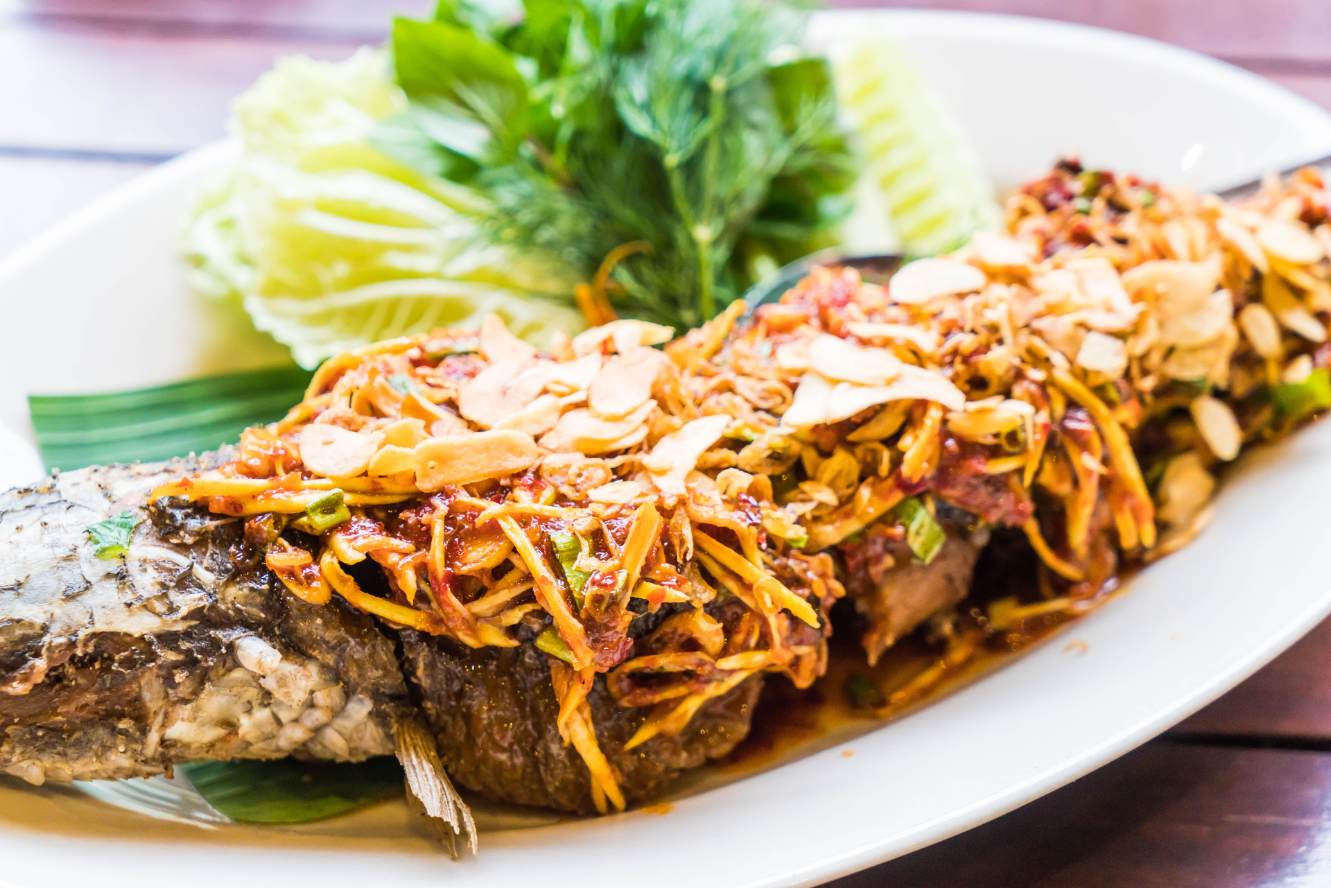 Overhead flat-lay of all ingredients for Mchuzi wa Samaki laid out on a kitchen surface.