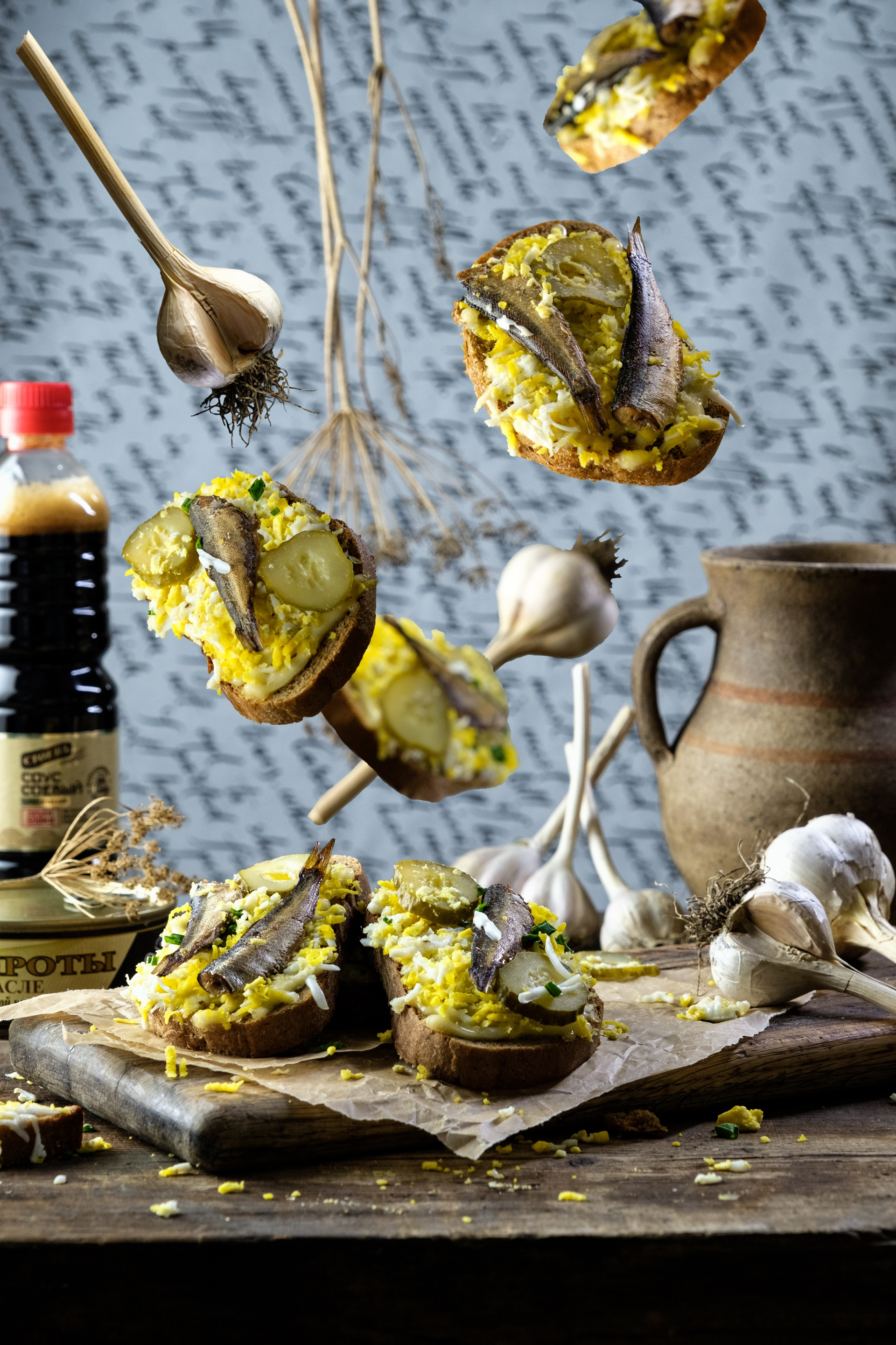 Overhead flat-lay of all ingredients for Mediterranean Artichoke and Herb Stuffed Bread with Olive Oil Drizzle laid out on a kitchen surface.