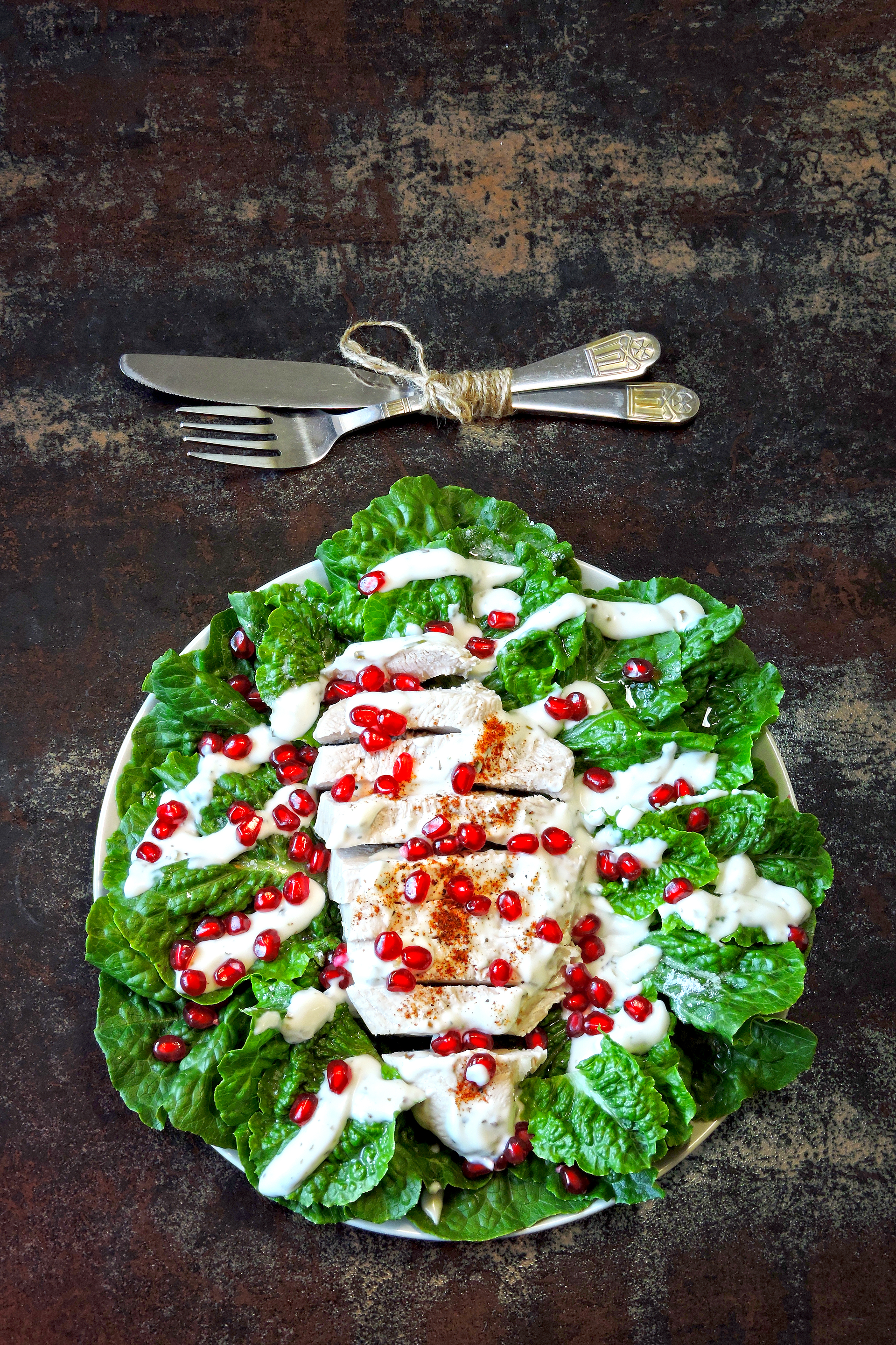 Overhead flat-lay of all ingredients for Mediterranean Grilled Chicken with Tzatziki Sauce laid out on a kitchen surface.