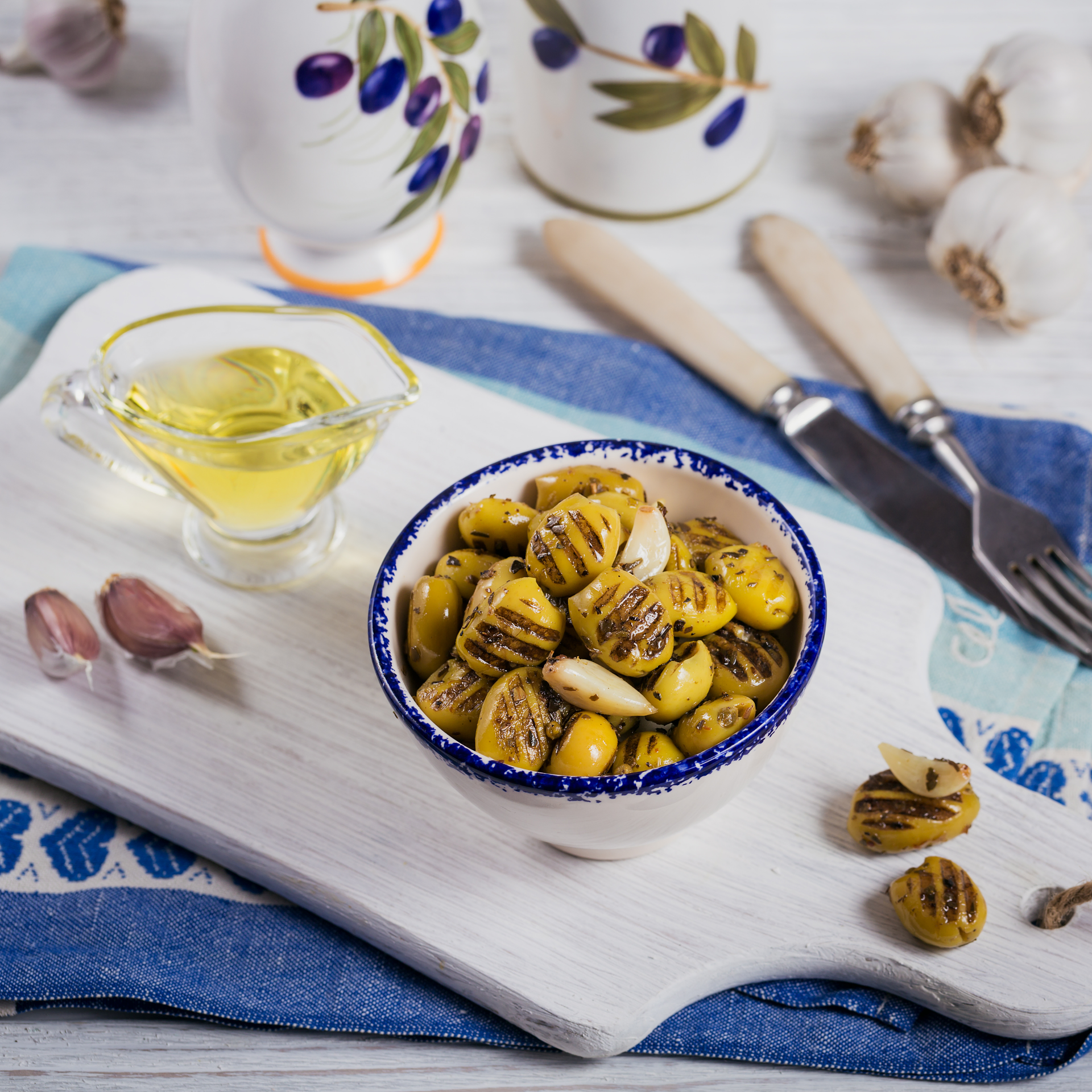 Overhead flat-lay of all ingredients for Mediterranean Lemon Roasted Artichoke Hearts with Capers laid out on a kitchen surface.