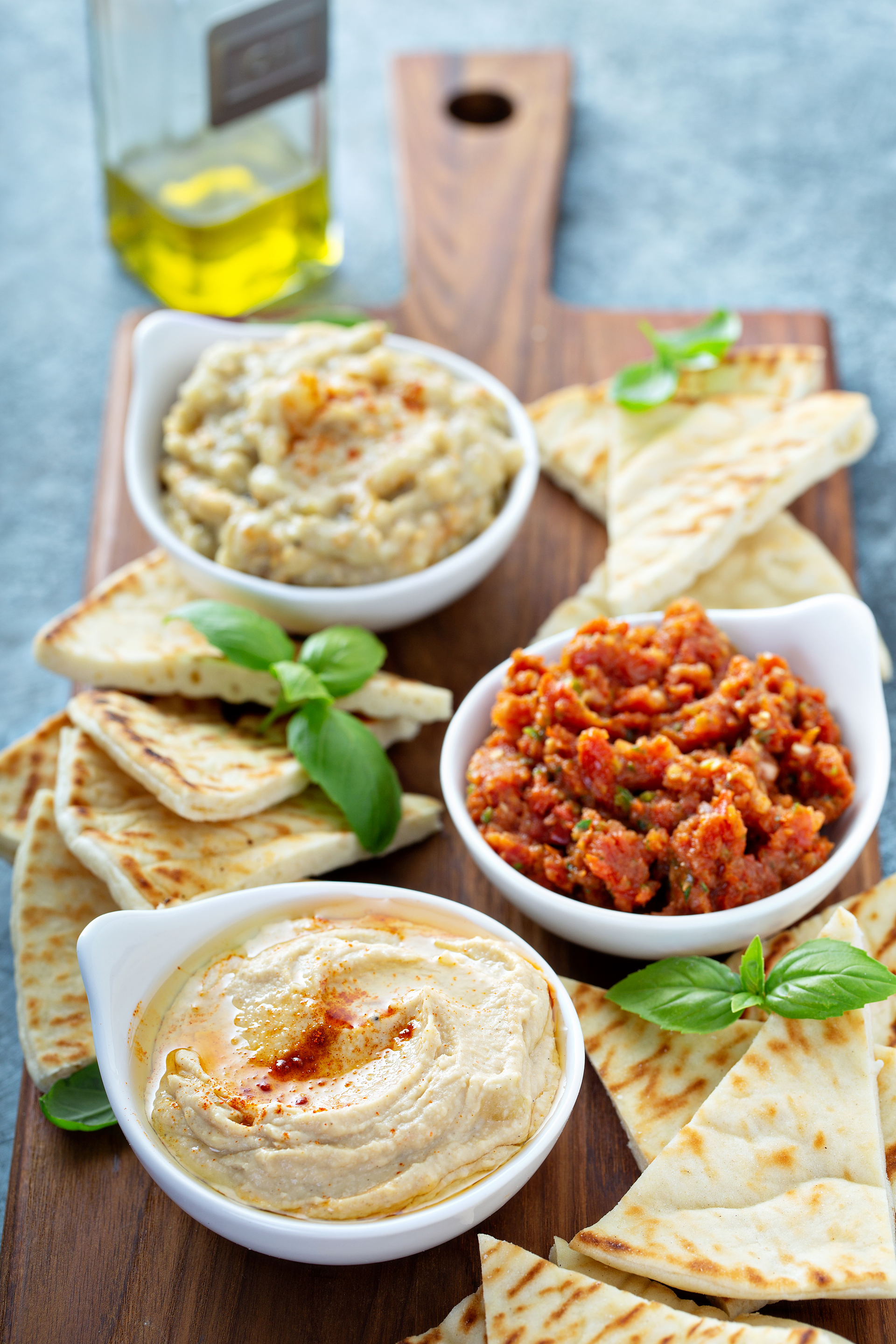 Overhead flat-lay of all ingredients for Mediterranean Za'atar Pita Chips with Spiced Hummus laid out on a kitchen surface.