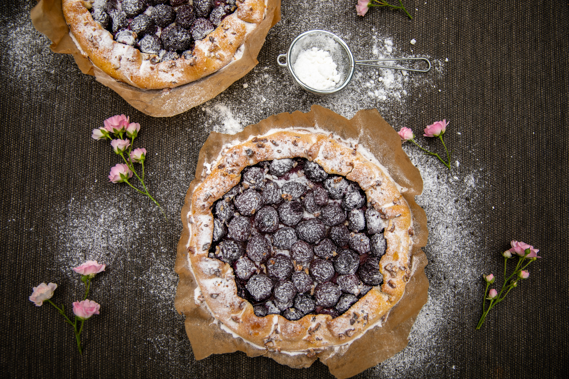 Overhead flat-lay of all ingredients for Mellow Finnish Mustikkapiirakka with Cardamom Crust laid out on a kitchen surface.