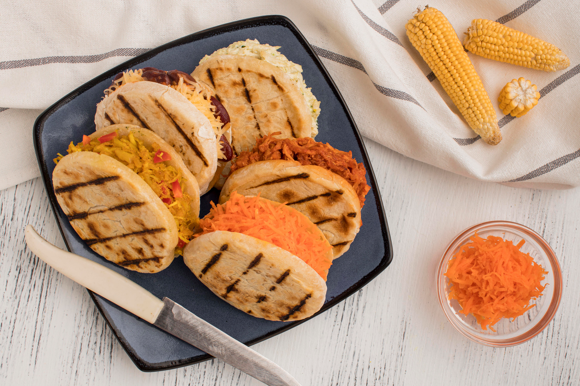 Overhead flat-lay of all ingredients for Mexican Chorizo and Cheese Pupusas with Curtido laid out on a kitchen surface.