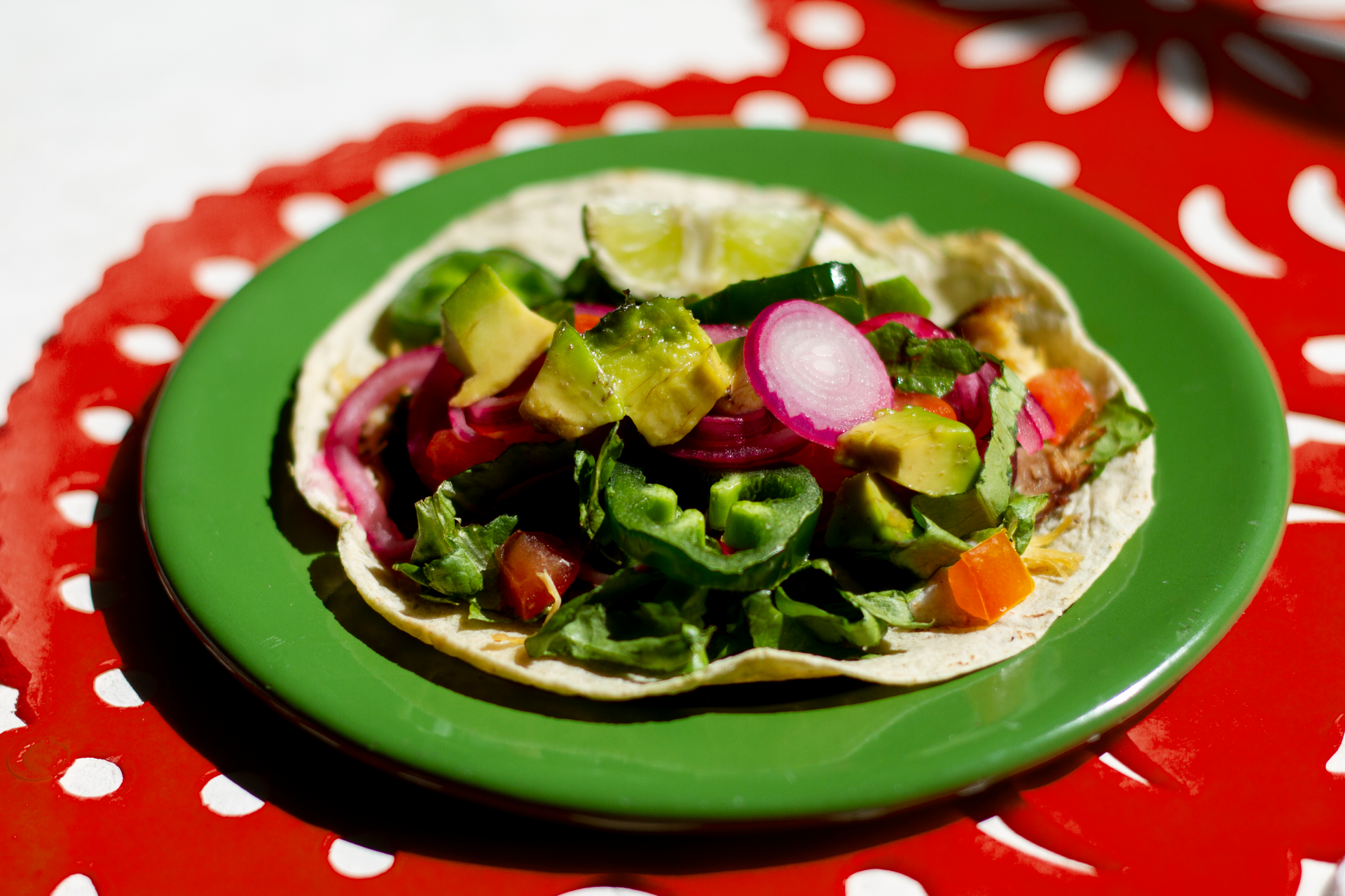 Overhead flat-lay of all ingredients for Mexican Nopales Salad with Queso Fresco and Lime laid out on a kitchen surface.