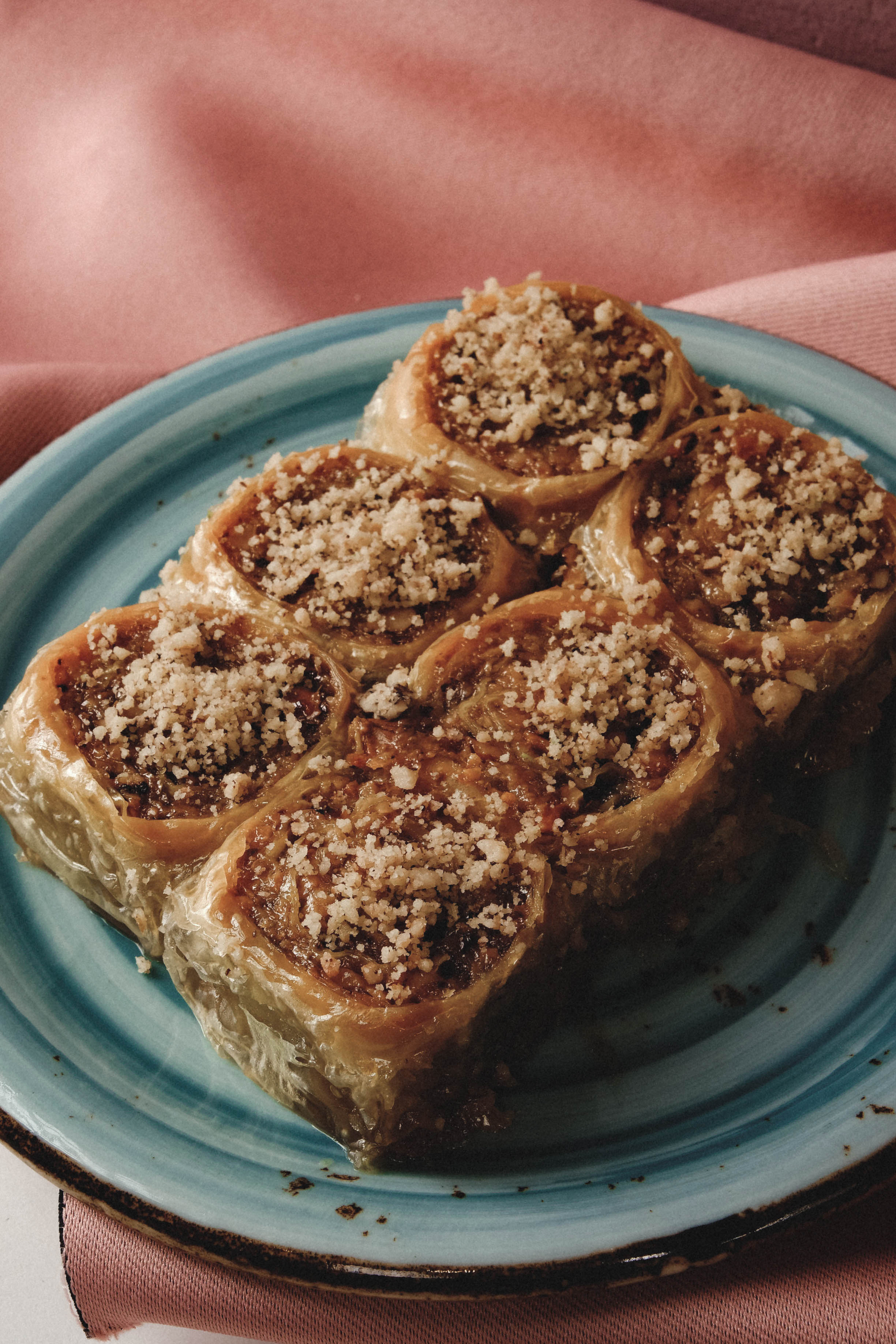 Overhead flat-lay of all ingredients for Middle Eastern Babka with Dates and Pistachios laid out on a kitchen surface.