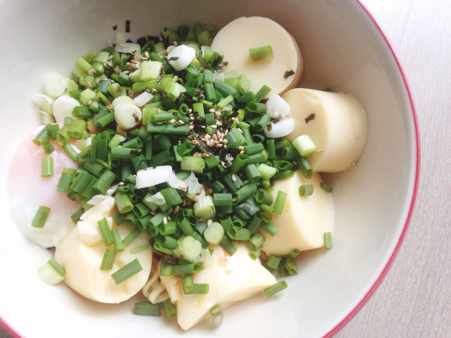 Overhead flat-lay of all ingredients for Miso-Braised Japanese Daikon with Scallions laid out on a kitchen surface.
