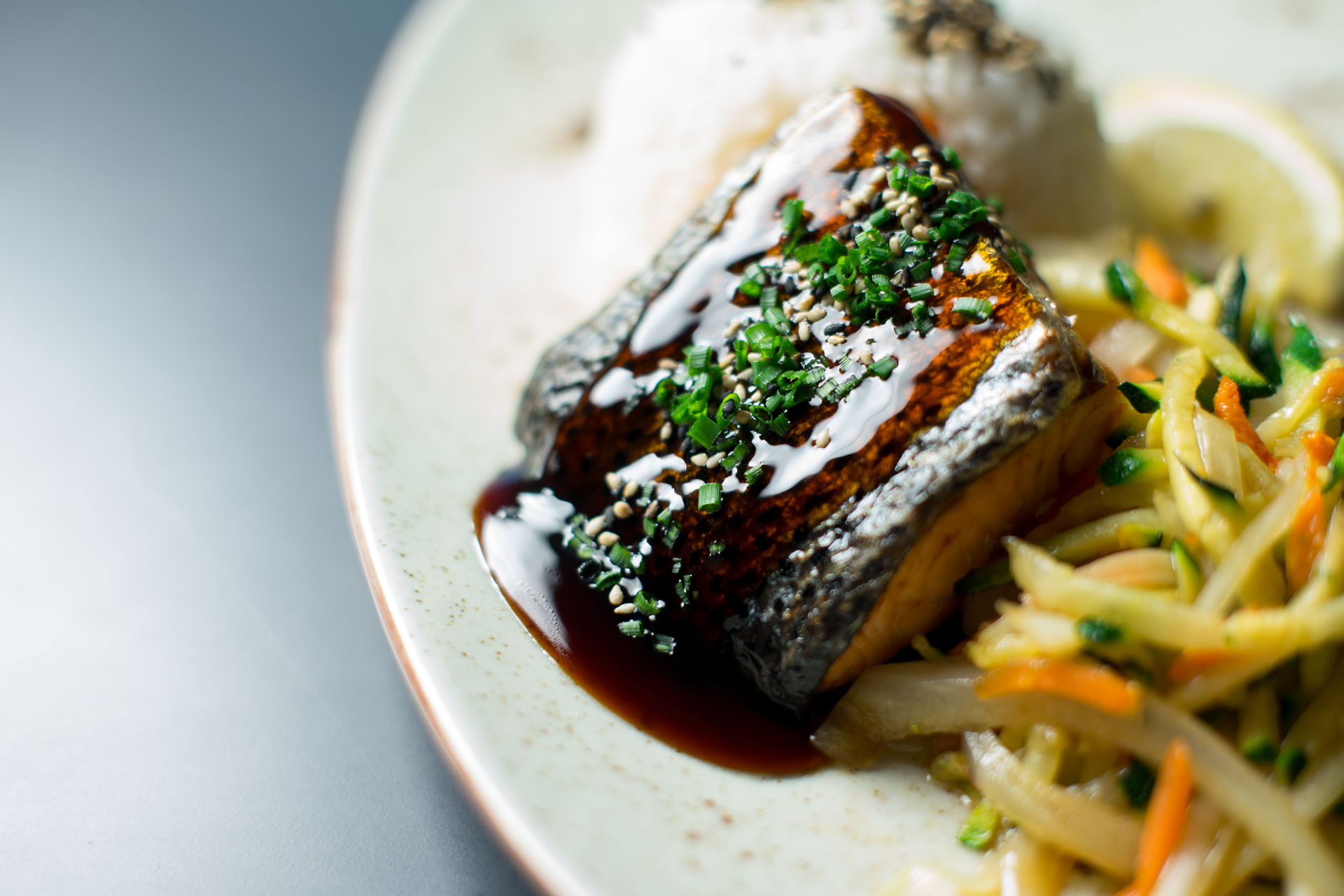 Overhead flat-lay of all ingredients for Miso-Glazed Black Cod laid out on a kitchen surface.