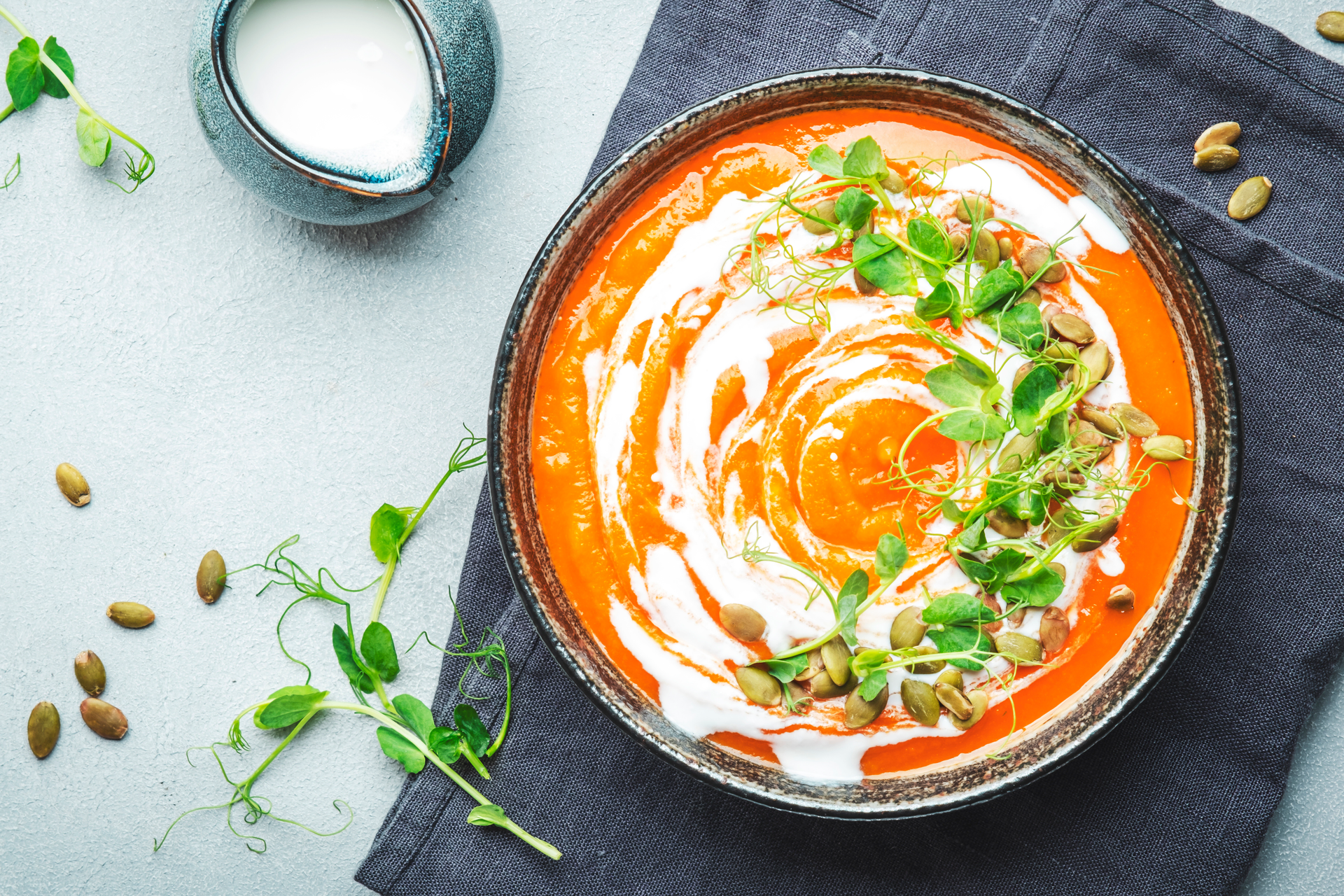 Overhead flat-lay of all ingredients for Moroccan Carrot Saffron Stew with Almond Tarator laid out on a kitchen surface.