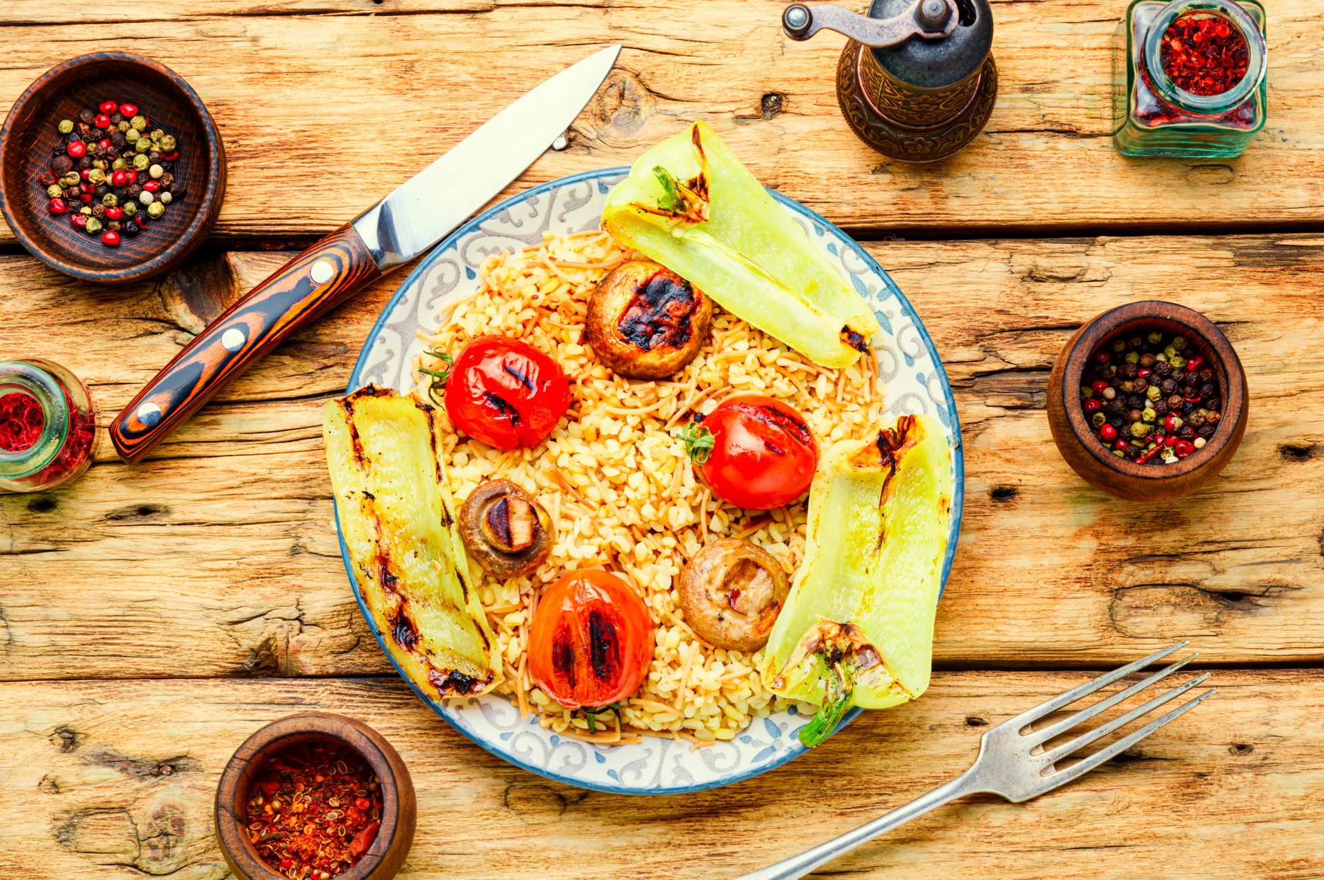 Overhead flat-lay of all ingredients for Moroccan Lemon Herb Couscous with Roasted Vegetables laid out on a kitchen surface.