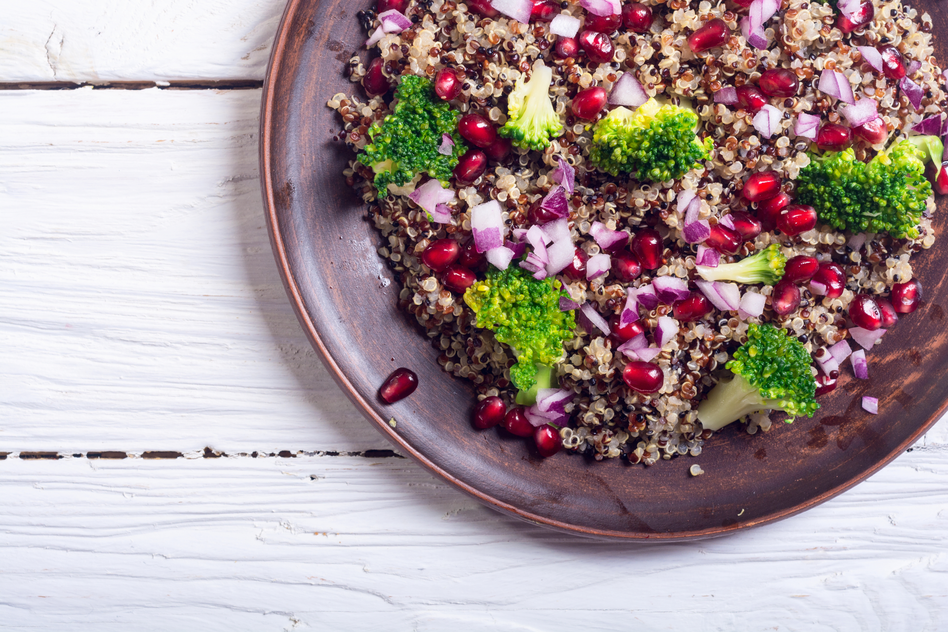 Overhead flat-lay of all ingredients for Moroccan Quinoa Couscous with Figs and Harissa Vinaigrette laid out on a kitchen surface.