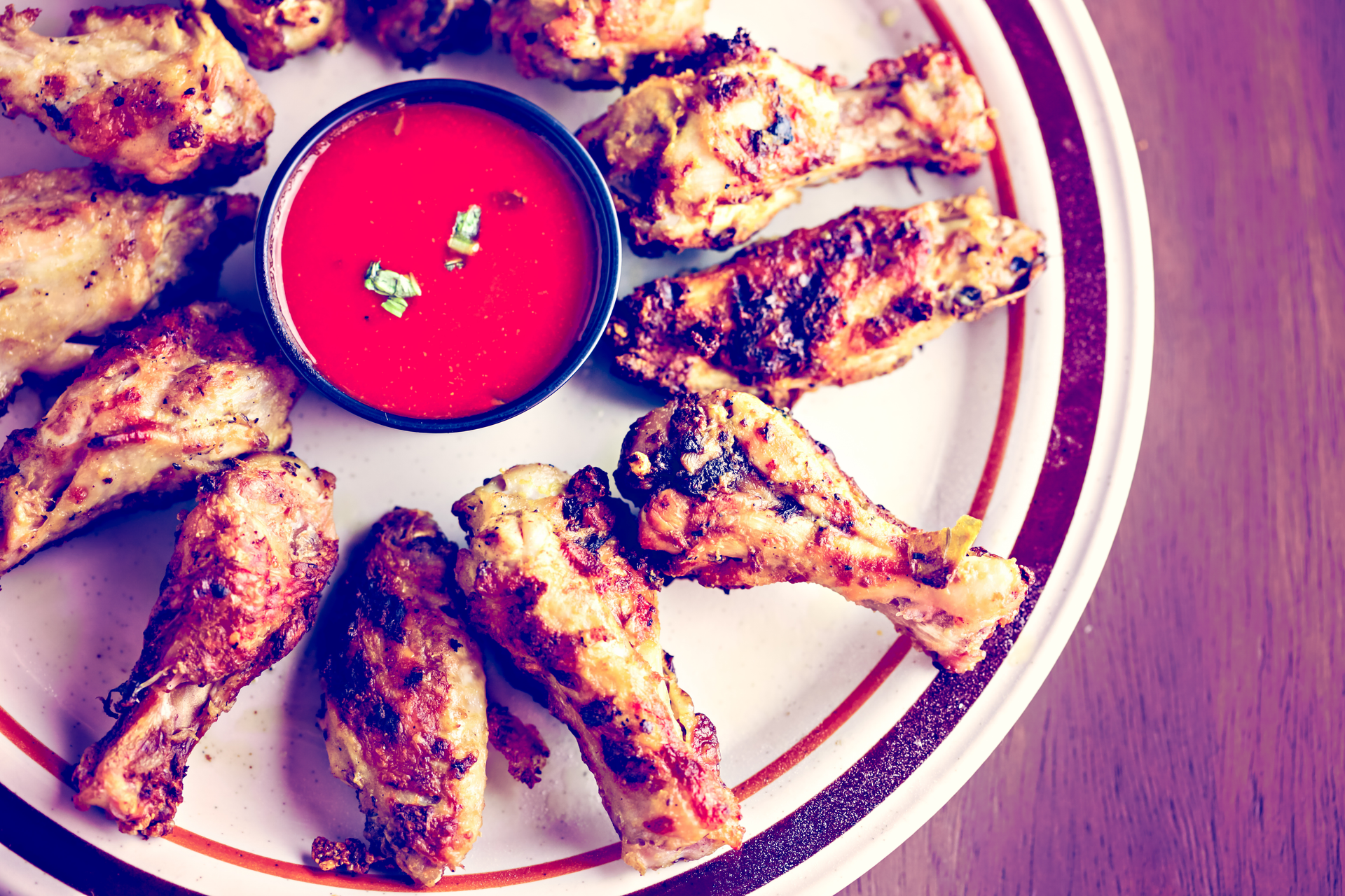 Overhead flat-lay of all ingredients for Moroccan Ras El Hanout Chicken Wings with Pomegranate Glaze laid out on a kitchen surface.