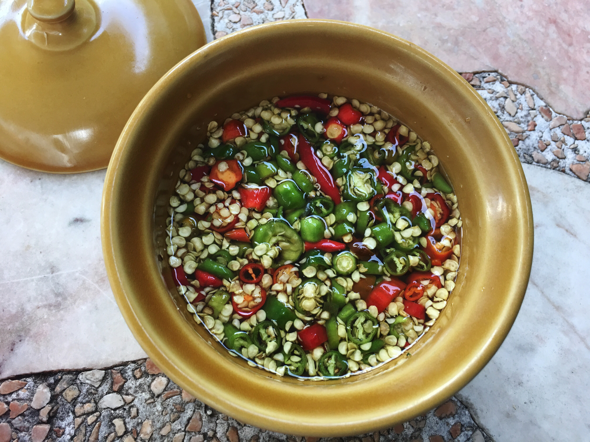 Overhead flat-lay of all ingredients for Moroccan Spiced Lentil and Quinoa Salad with Harissa Vinaigrette laid out on a kitchen surface.