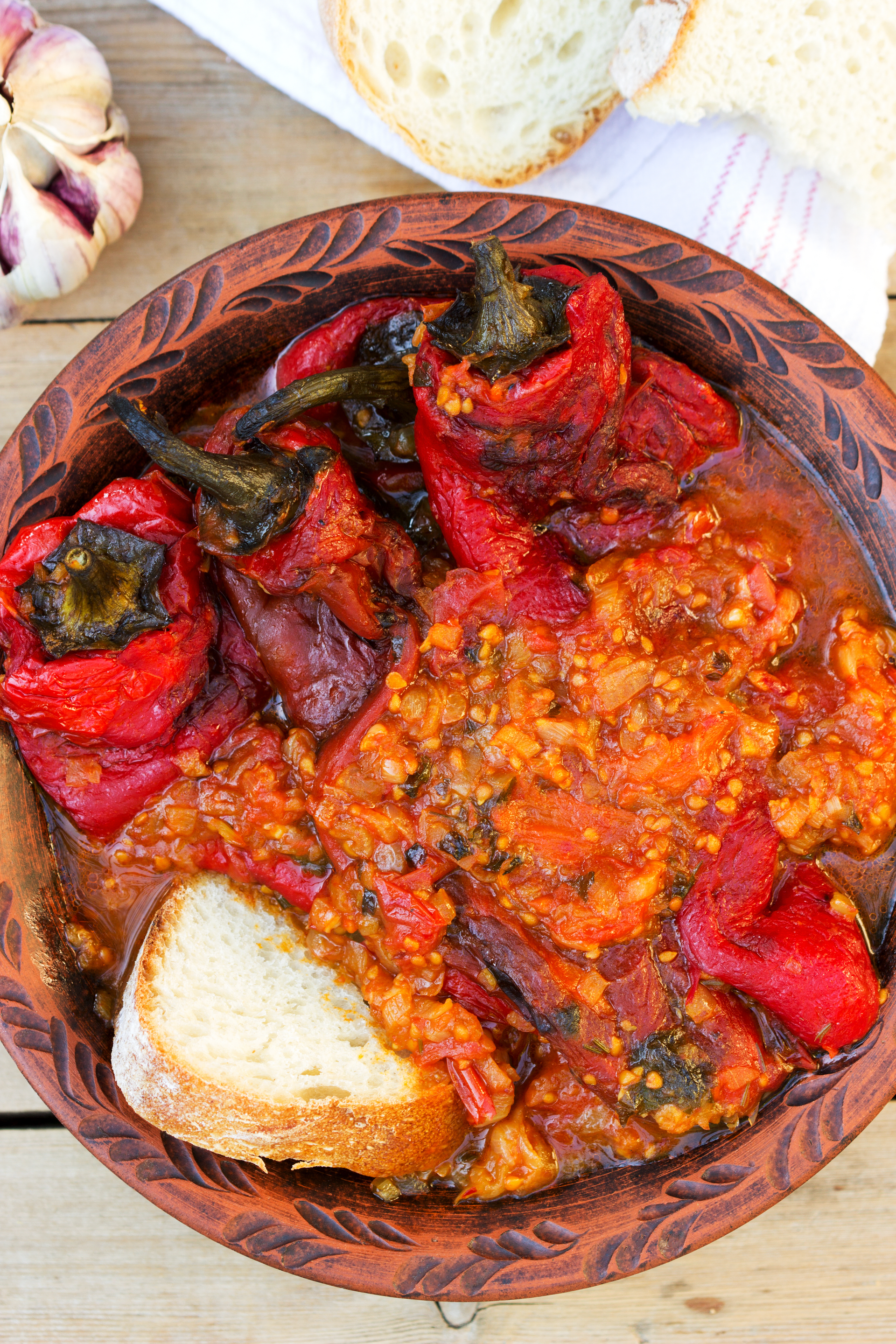 Overhead flat-lay of all ingredients for Moroccan Zaalouk with Roasted Peppers and Paprika laid out on a kitchen surface.
