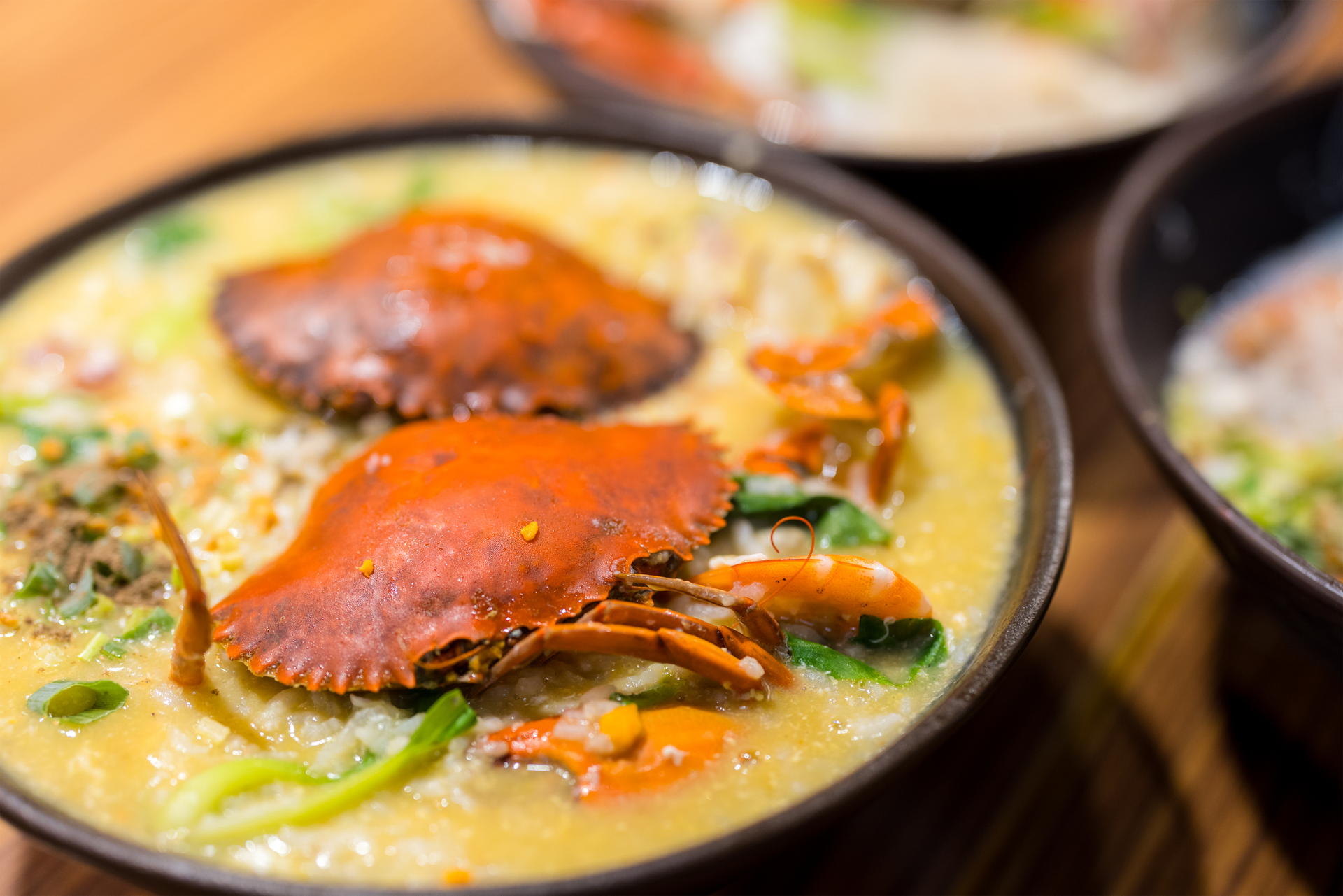 Overhead flat-lay of all ingredients for Mozambique Curry Crab Soup with Coconut Ginger laid out on a kitchen surface.