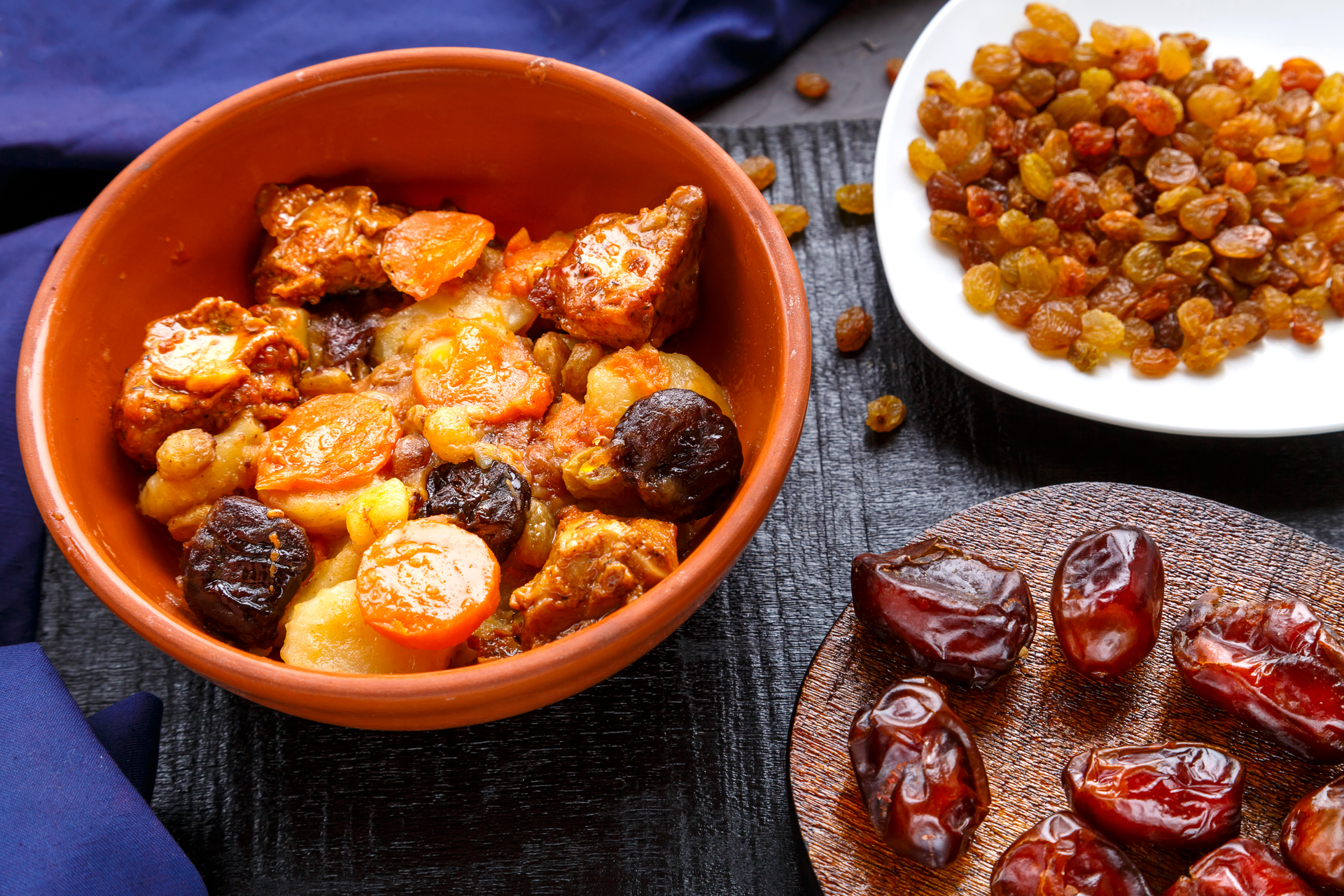 Overhead flat-lay of all ingredients for North African Berber Tagoula with Mixed Nuts and Dates laid out on a kitchen surface.