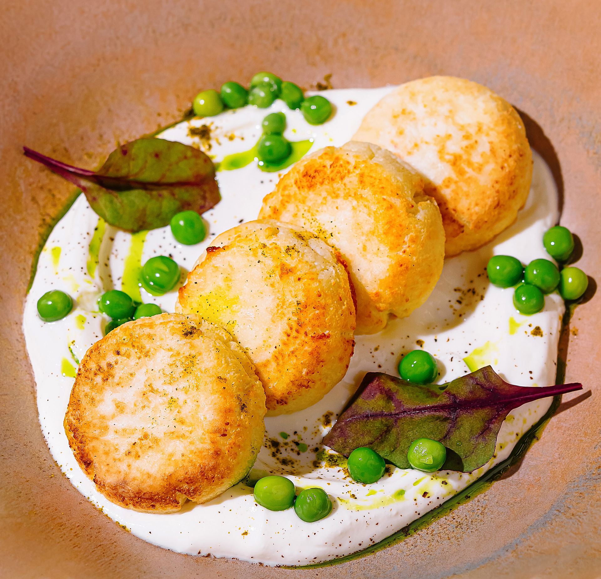 Overhead flat-lay of all ingredients for Norwegian Fiskeboller with White Sauce and Peas laid out on a kitchen surface.