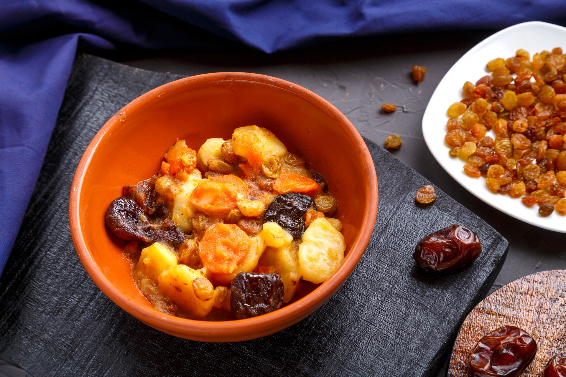 Overhead flat-lay of all ingredients for Nutty African Groundnut Stew with Sweet Potatoes laid out on a kitchen surface.