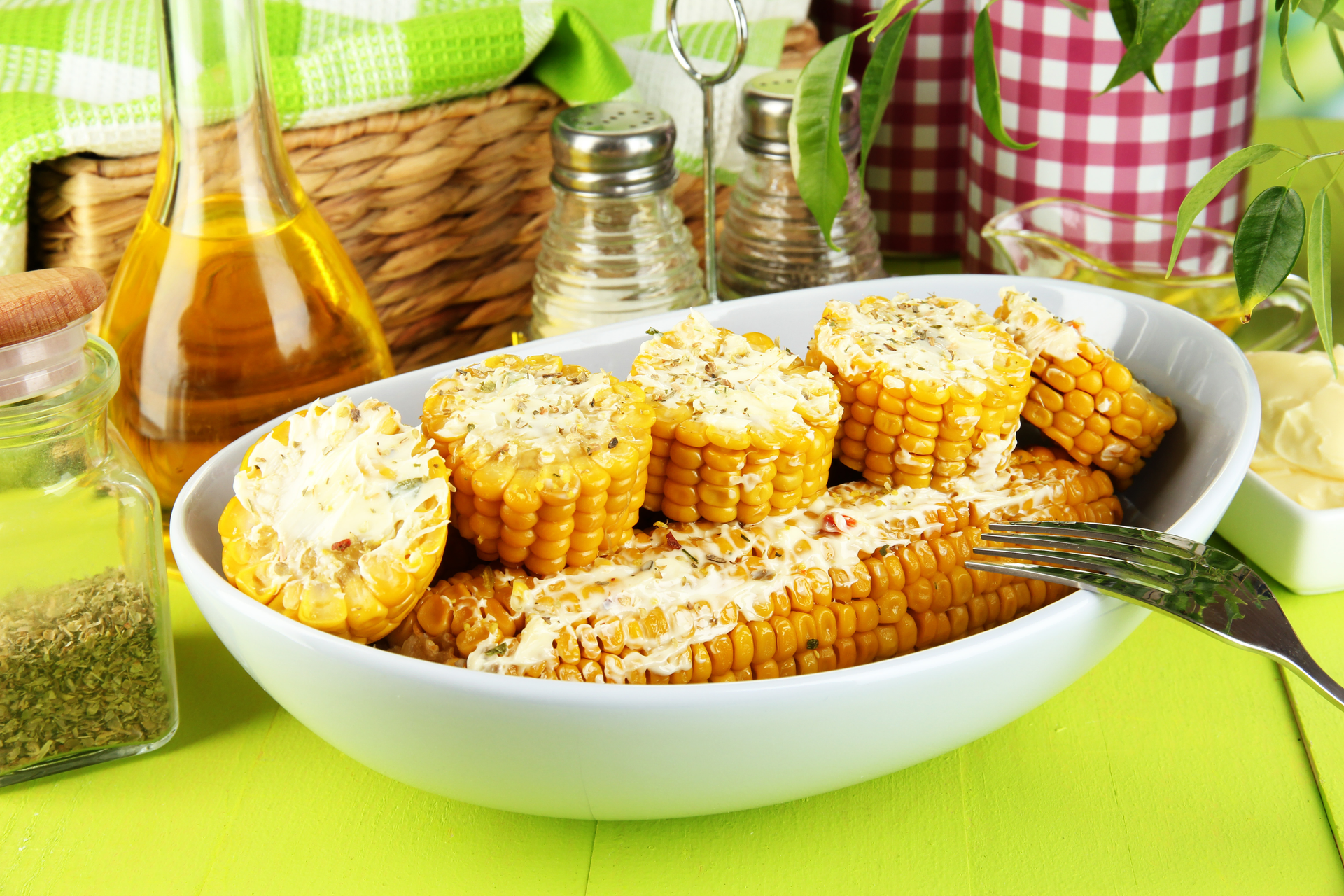 Overhead flat-lay of all ingredients for Nutty Brazilian Pamonha with Fresh Corn and Cheese laid out on a kitchen surface.