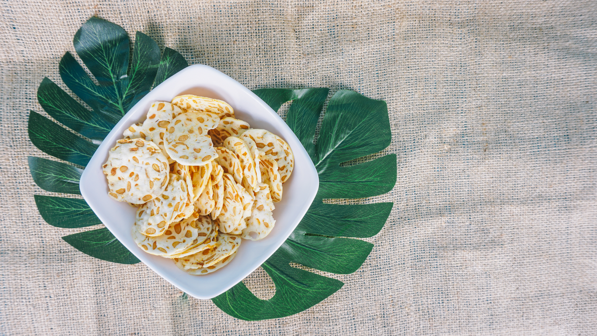 Overhead flat-lay of all ingredients for Nutty Burmese Peanut Brittle with Coconut Flakes laid out on a kitchen surface.