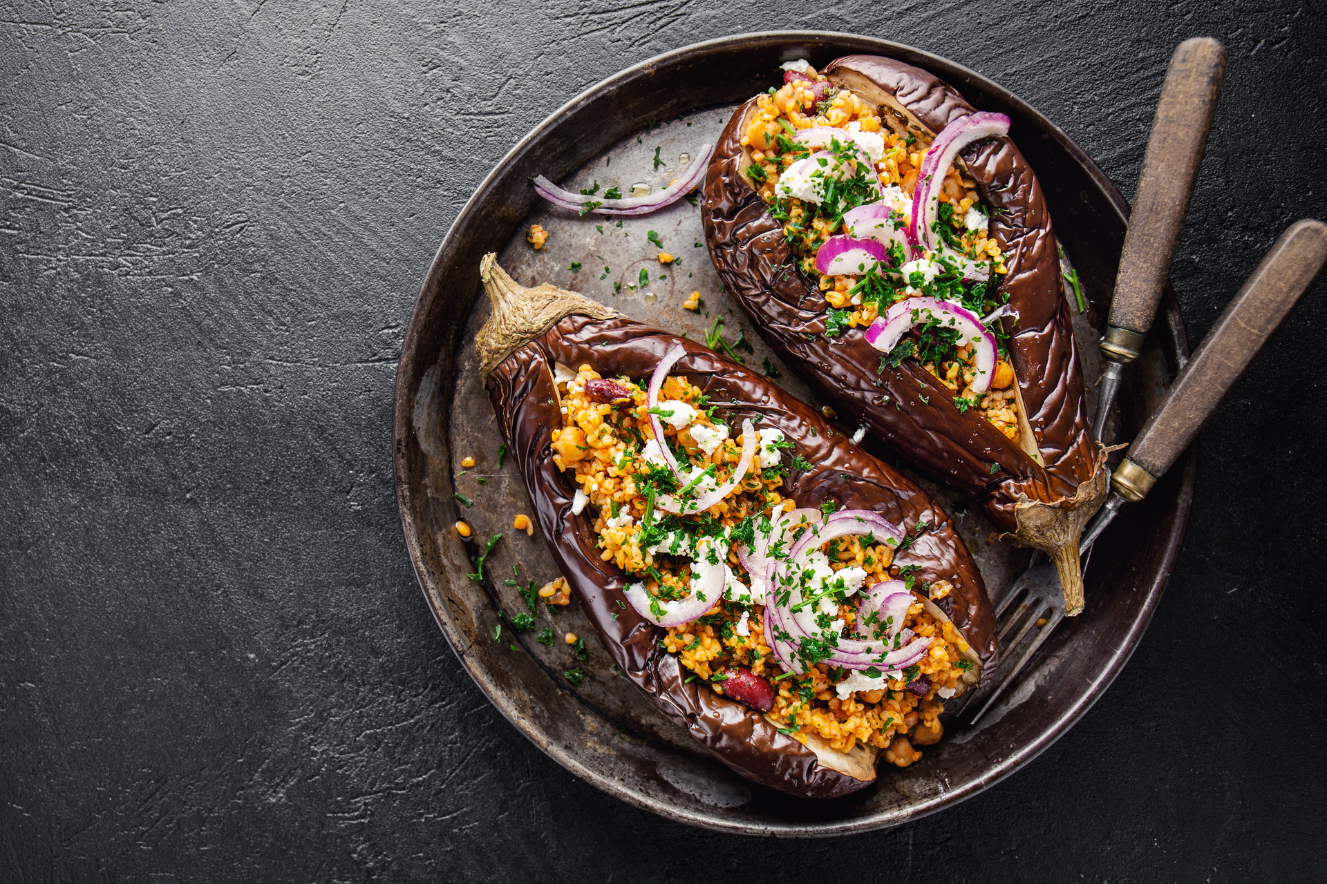 Overhead flat-lay of all ingredients for Nutty Egyptian Dukkah Crusted Eggplant with Tahini Drizzle laid out on a kitchen surface.