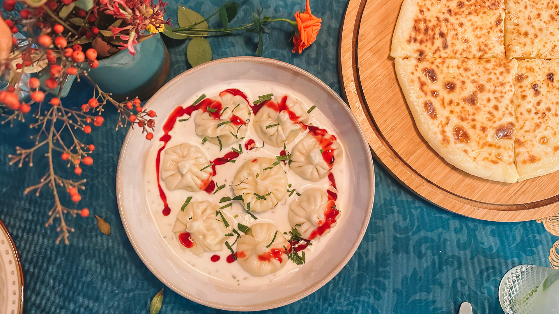 Overhead flat-lay of all ingredients for Nutty Georgian Chicken Satsivi laid out on a kitchen surface.