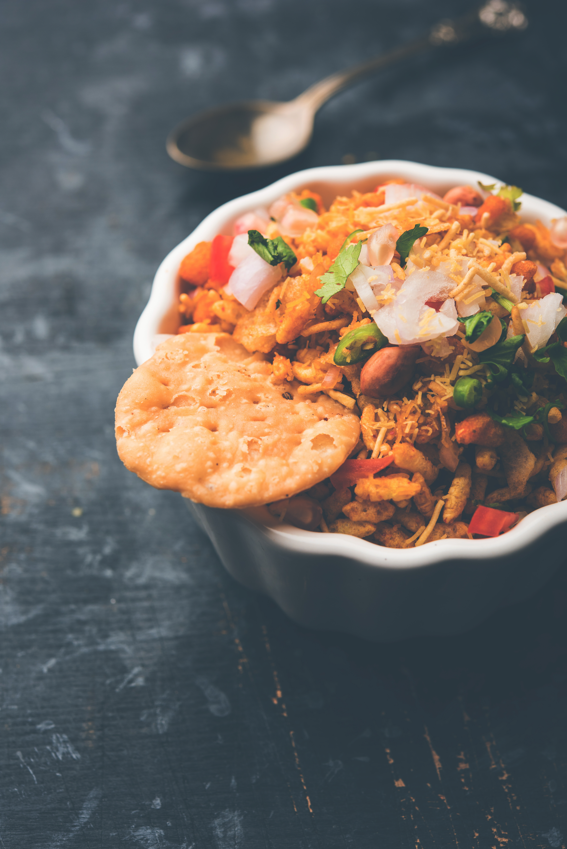 Overhead flat-lay of all ingredients for Nutty Indian Bhel Puri Salad with Tamarind Chutney laid out on a kitchen surface.