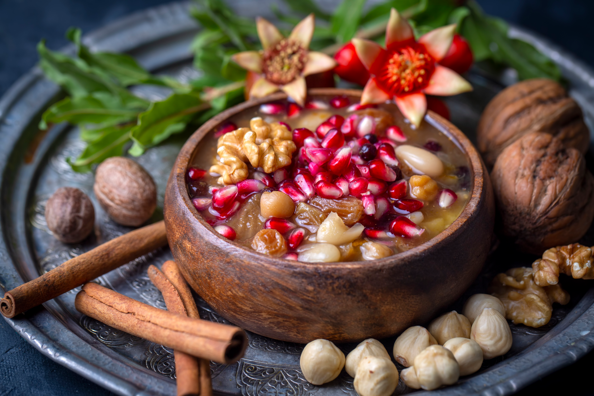 Overhead flat-lay of all ingredients for Nutty Iranian Fesenjan with Walnuts and Pomegranate laid out on a kitchen surface.
