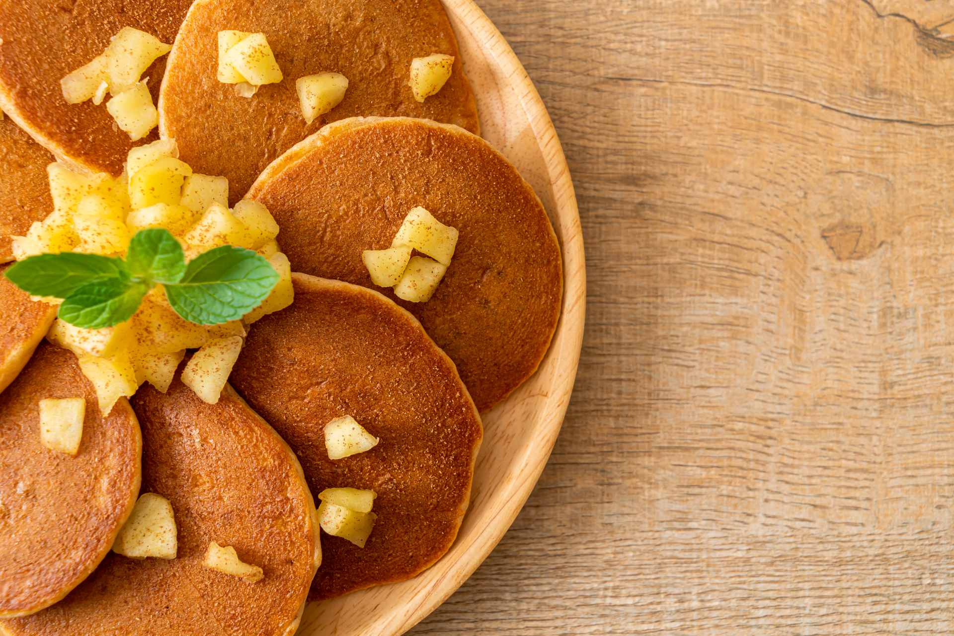 Overhead flat-lay of all ingredients for Nutty Malaysian Peanut Butter Pineapple Pancakes laid out on a kitchen surface.