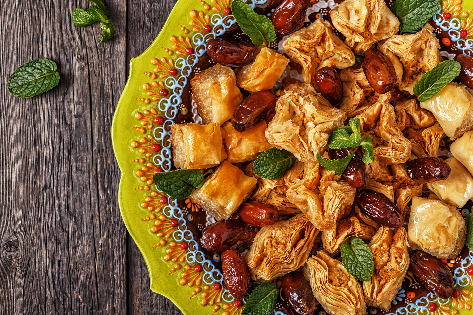 Overhead flat-lay of all ingredients for Nutty Moroccan B'stilla with Spiced Chicken and Phyllo laid out on a kitchen surface.