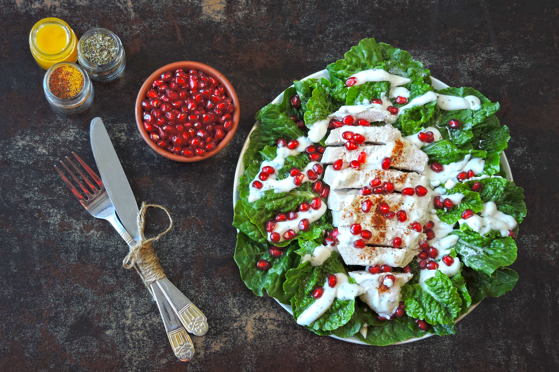 Overhead flat-lay of all ingredients for Palestinian Maftoul Salad with Sumac Yogurt Dressing laid out on a kitchen surface.