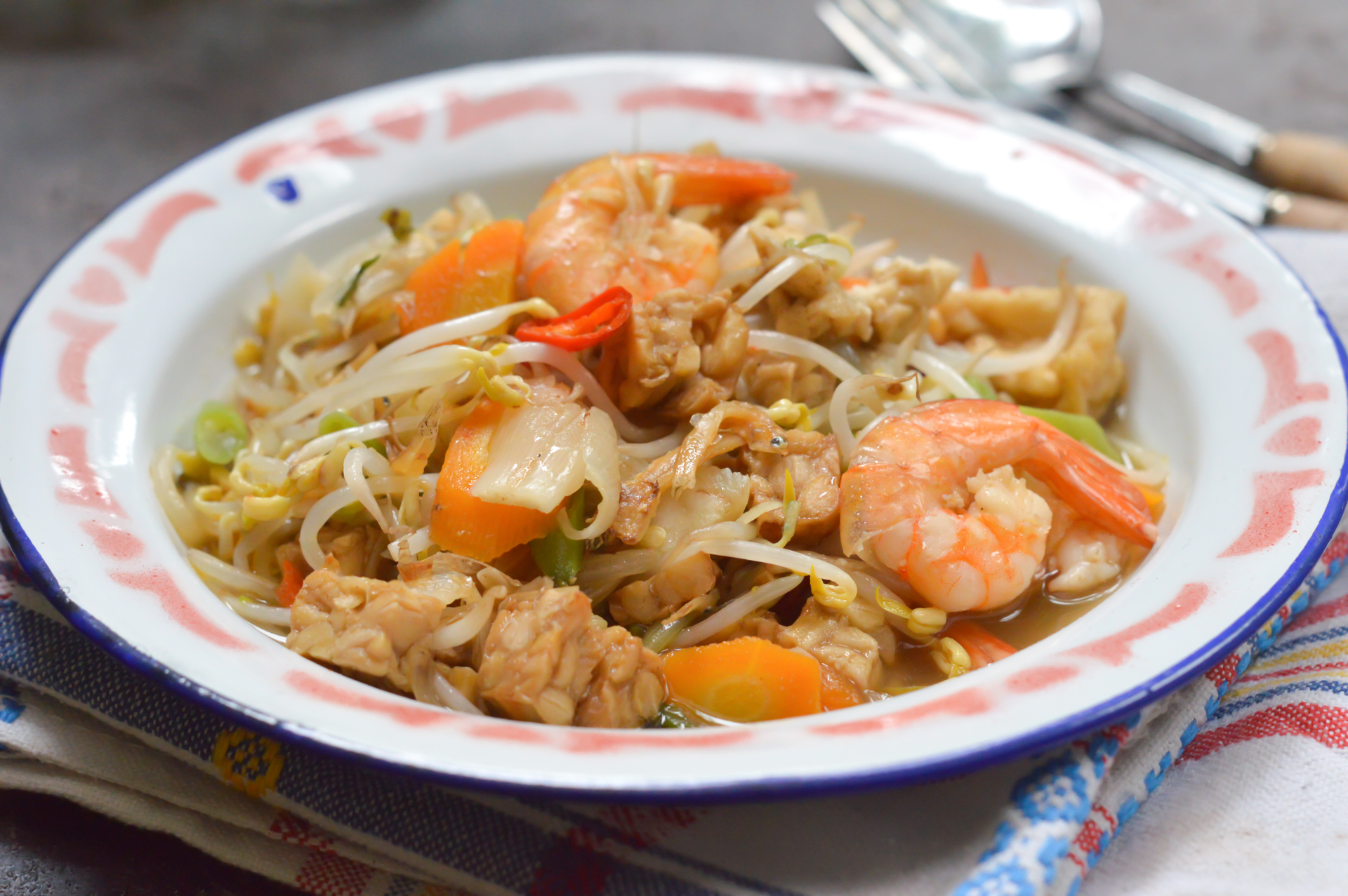 Overhead flat-lay of all ingredients for Pancit Malabon with Shrimp and Pork laid out on a kitchen surface.