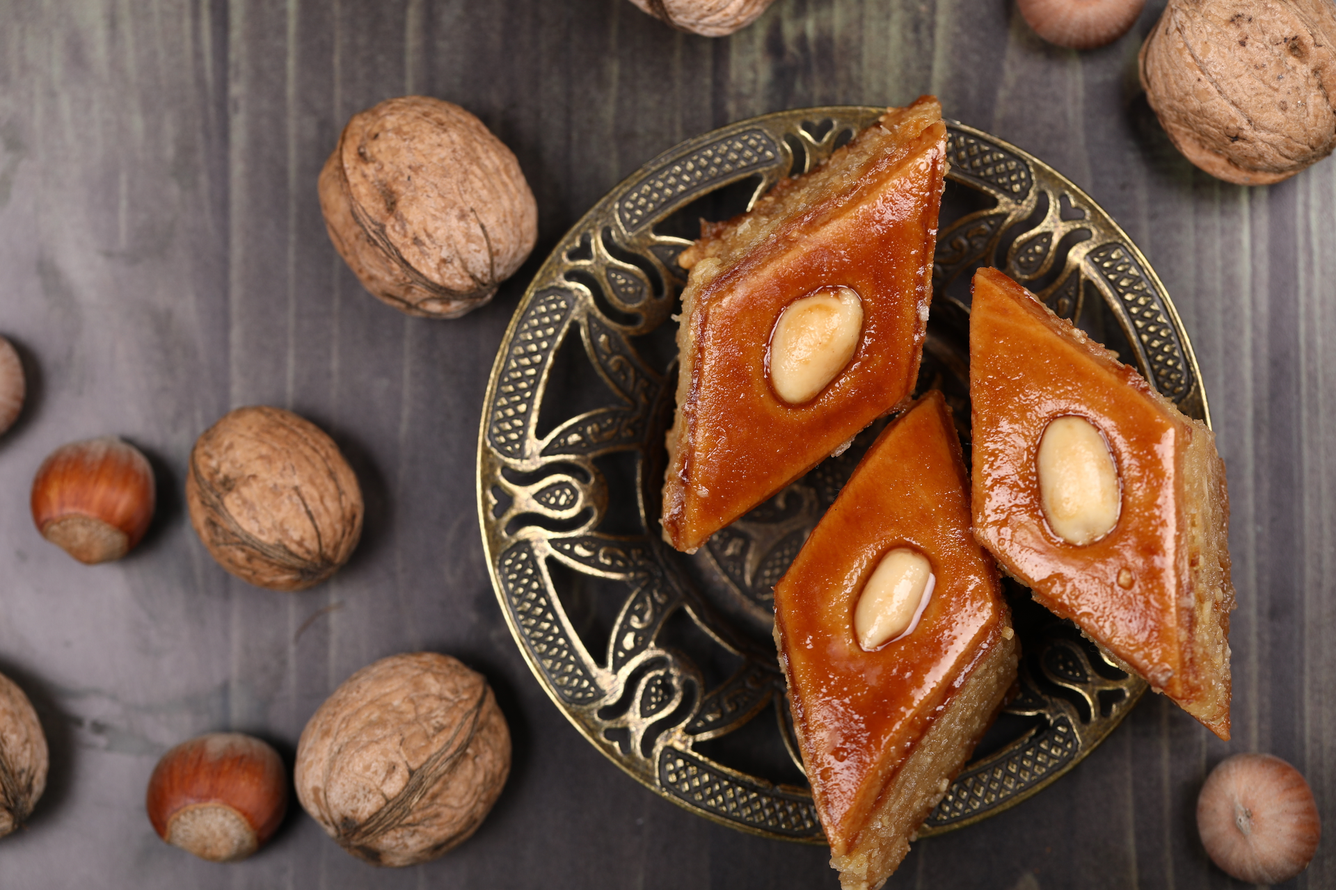 Overhead flat-lay of all ingredients for Persian Date and Walnut Baklava with Rose-Scented Syrup laid out on a kitchen surface.