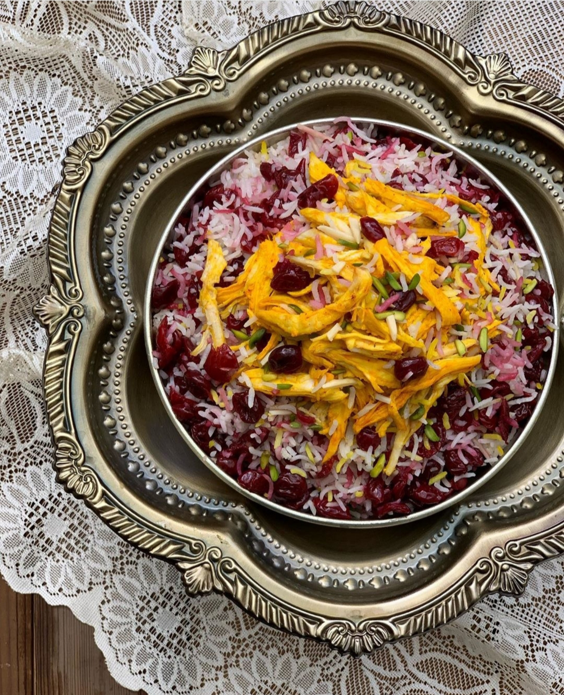 Overhead flat-lay of all ingredients for Persian Jeweled Rice with Barberries and Almonds laid out on a kitchen surface.