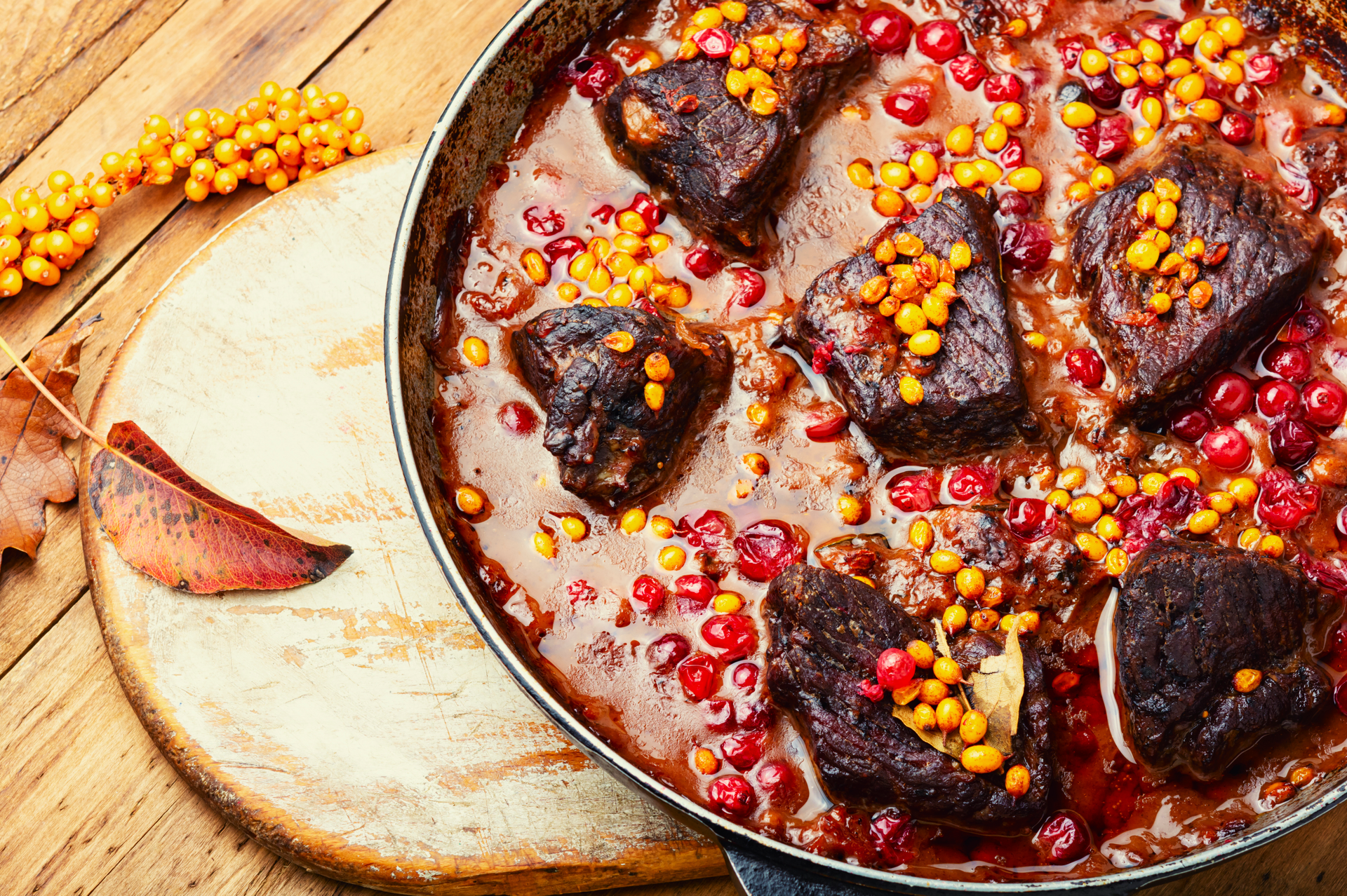 Overhead flat-lay of all ingredients for Persian Pomegranate Lamb Stew with Walnuts and Saffron laid out on a kitchen surface.