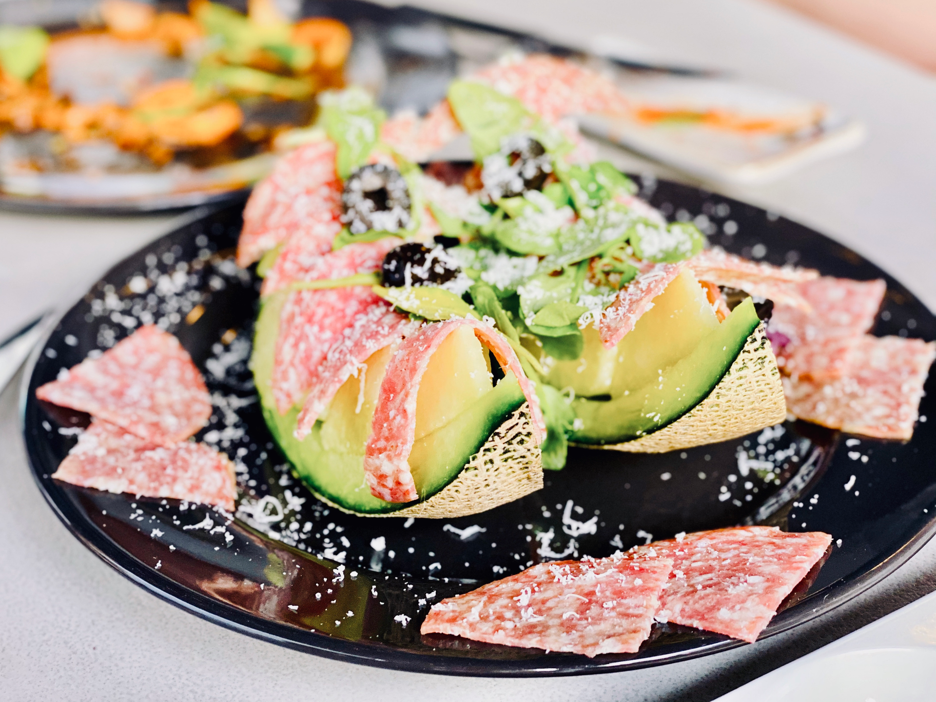Overhead flat-lay of all ingredients for Peruvian Avocado Lime Tartare with Quinoa Crisps laid out on a kitchen surface.