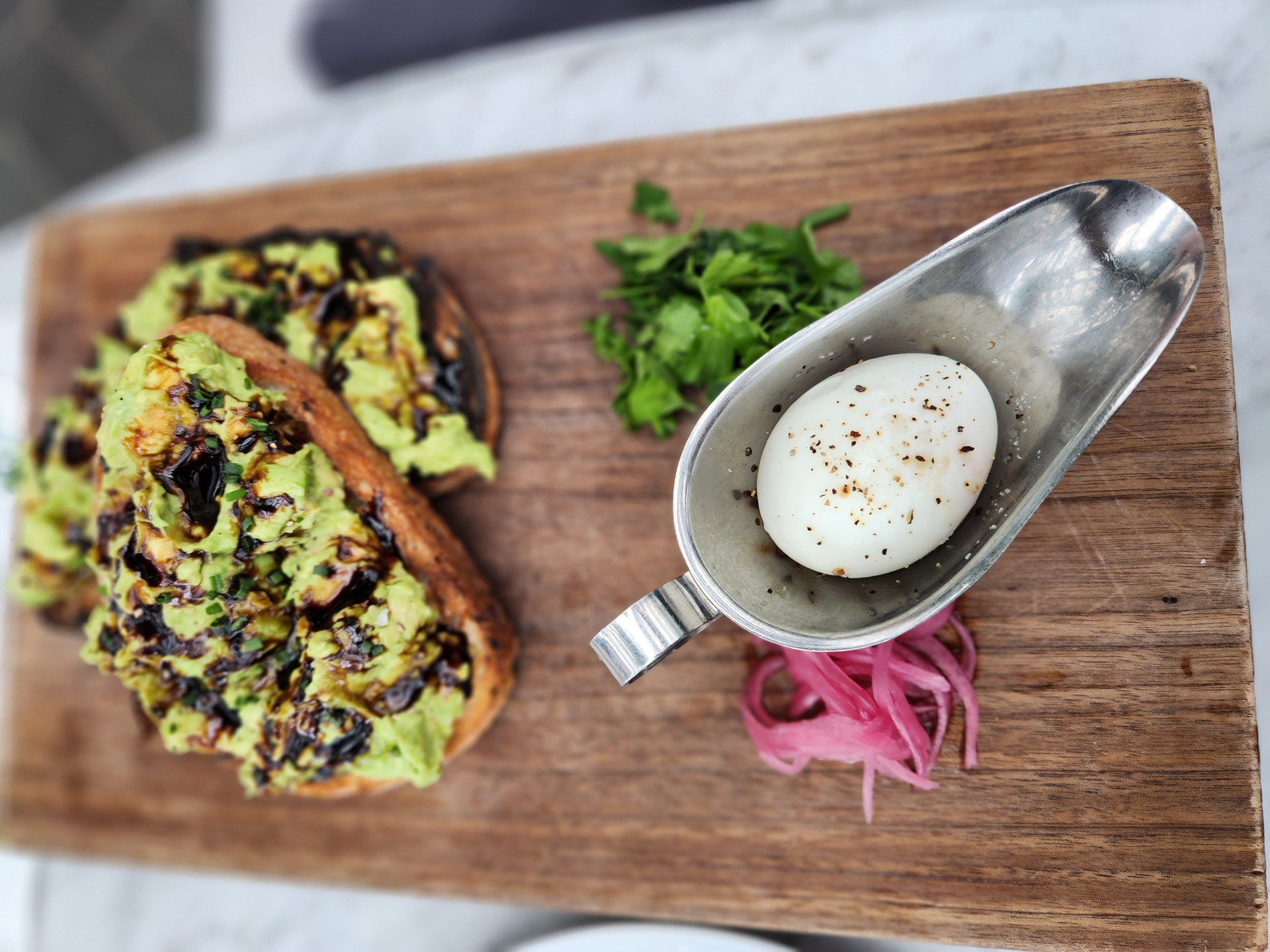Overhead flat-lay of all ingredients for Peruvian Causa Verde with Avocado Mousse and Quail Eggs laid out on a kitchen surface.