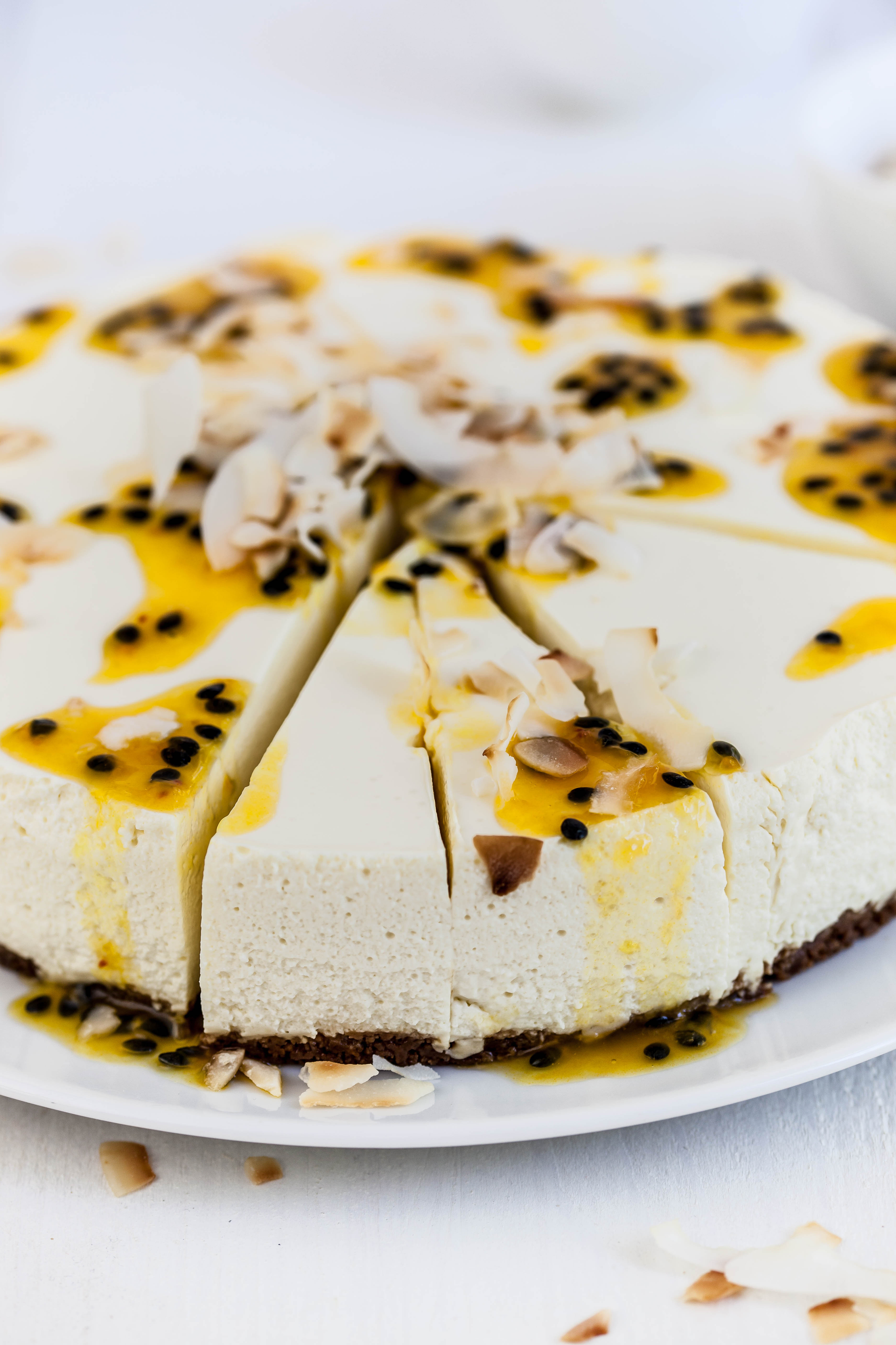 Overhead flat-lay of all ingredients for Peruvian Maracuya Cheesecake with Almond Crust laid out on a kitchen surface.