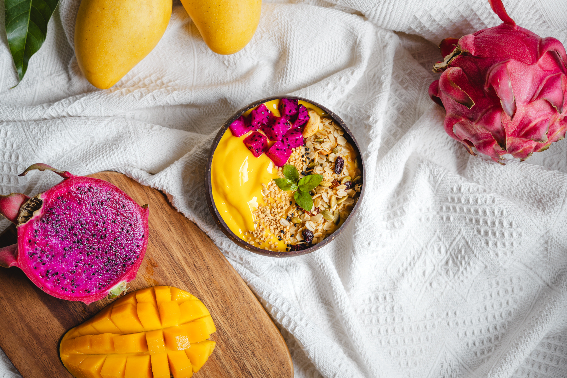 Overhead flat-lay of all ingredients for Peruvian Quinoa Parfait with Passion Fruit and Mango laid out on a kitchen surface.