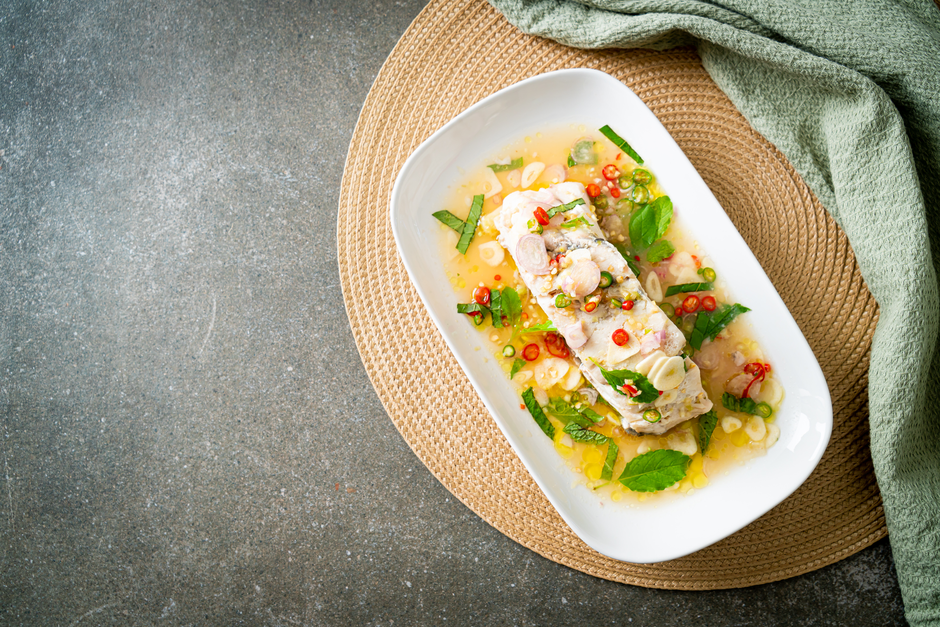Overhead flat-lay of all ingredients for Pinangat na Pompano in Coconut Cream laid out on a kitchen surface.