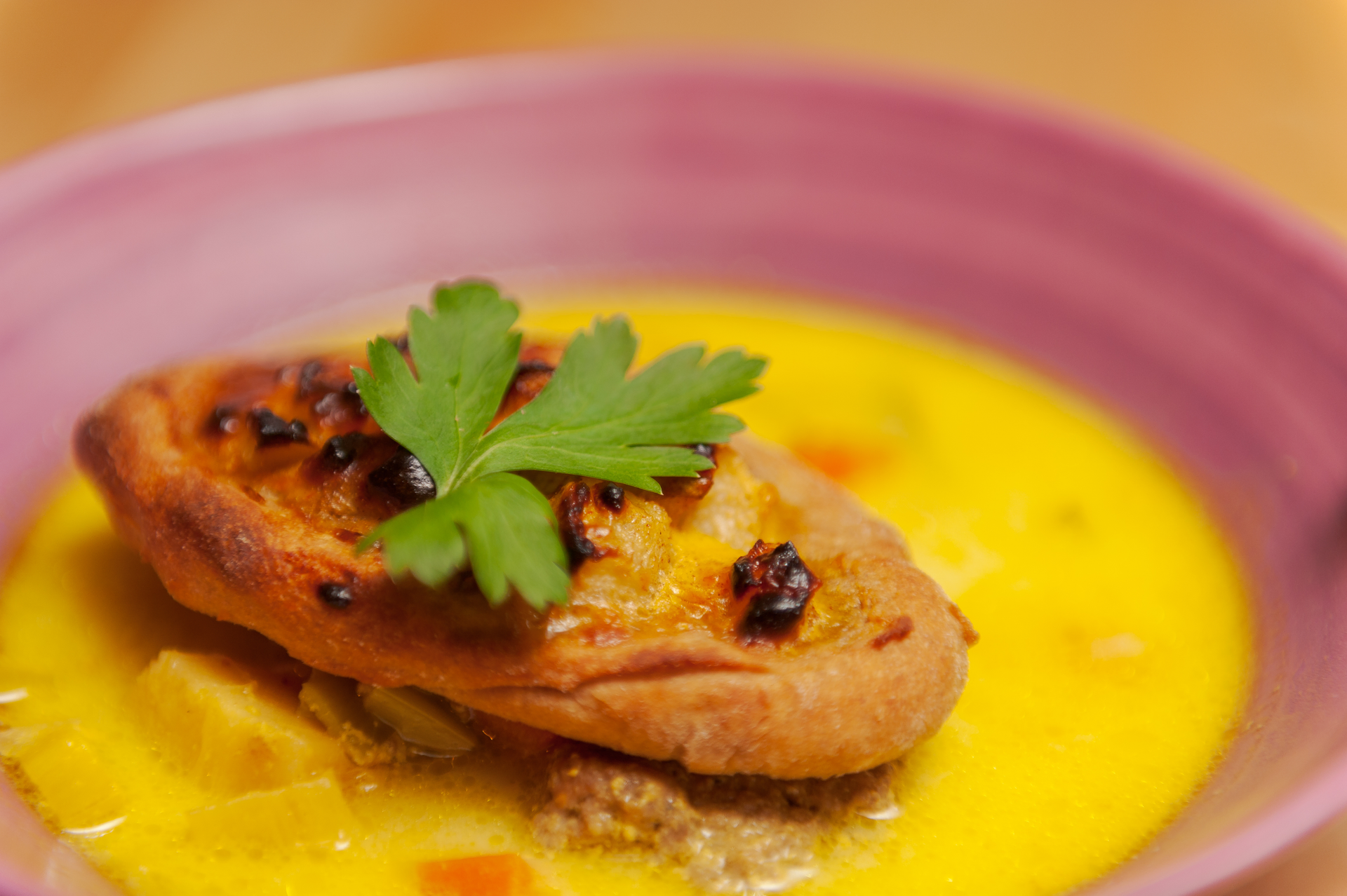 Overhead flat-lay of all ingredients for Piquant Bolivian Sajta de Pollo with Aji Amarillo laid out on a kitchen surface.