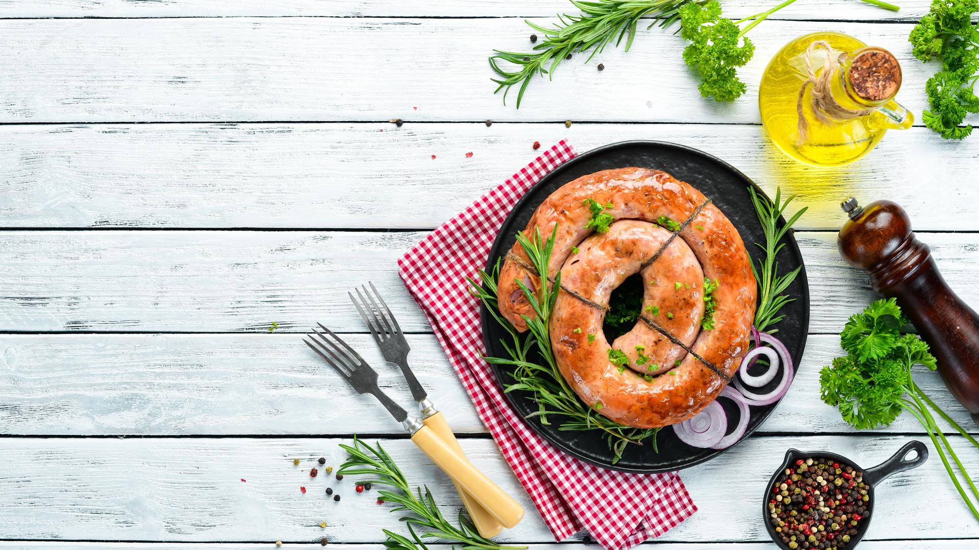 Overhead flat-lay of all ingredients for Polish Kiszka Sausage with Rye and Marjoram laid out on a kitchen surface.