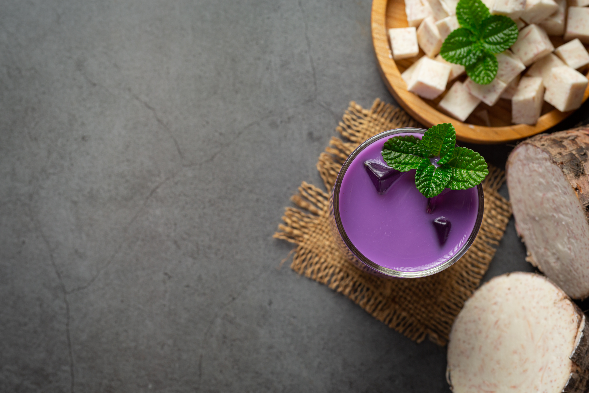 Overhead flat-lay of all ingredients for Polynesian Lu Pulu with Taro Leaf and Coconut Cream laid out on a kitchen surface.