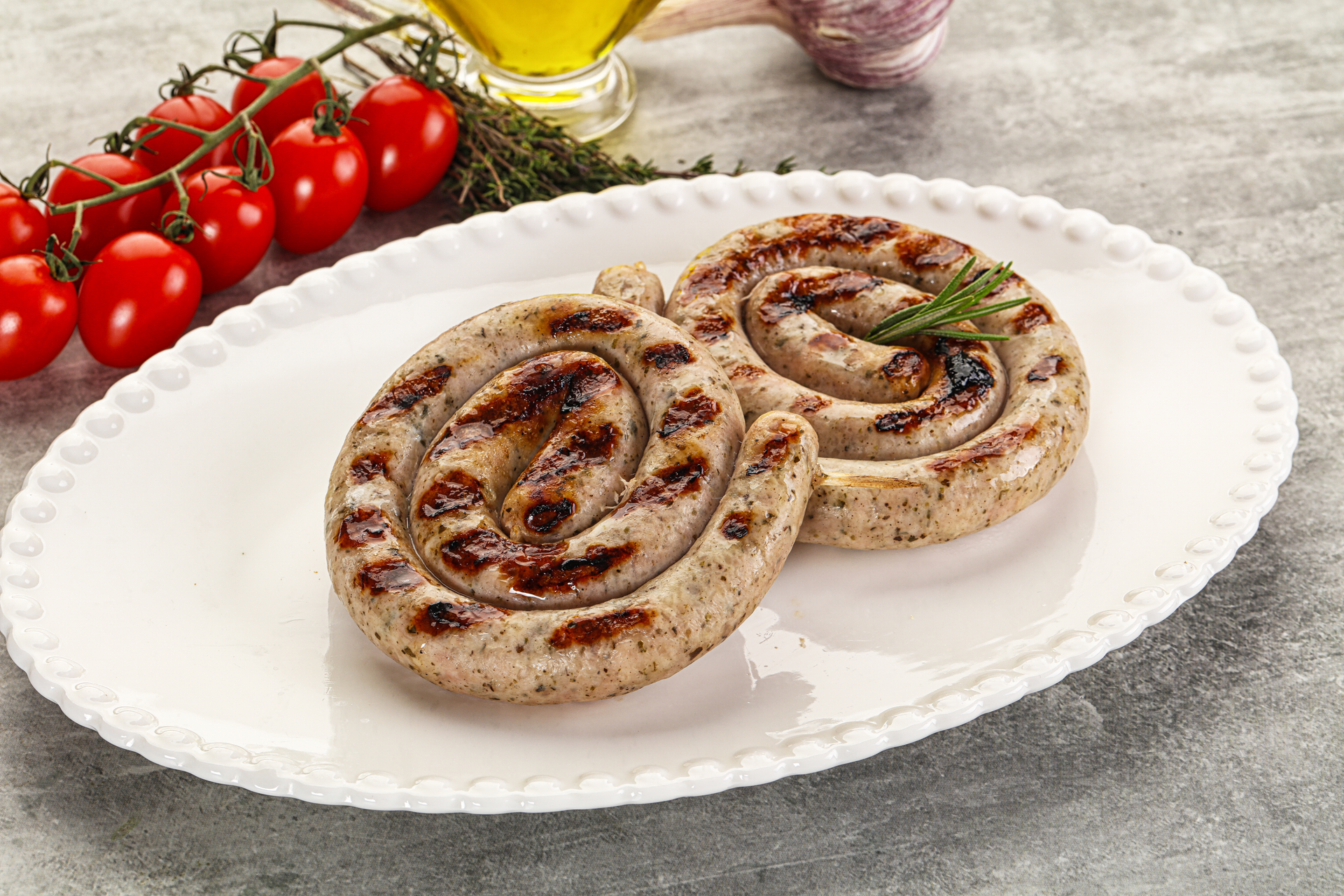 Overhead flat-lay of all ingredients for Portuguese Alheira Sausage Roulade with Olives and Peppers laid out on a kitchen surface.