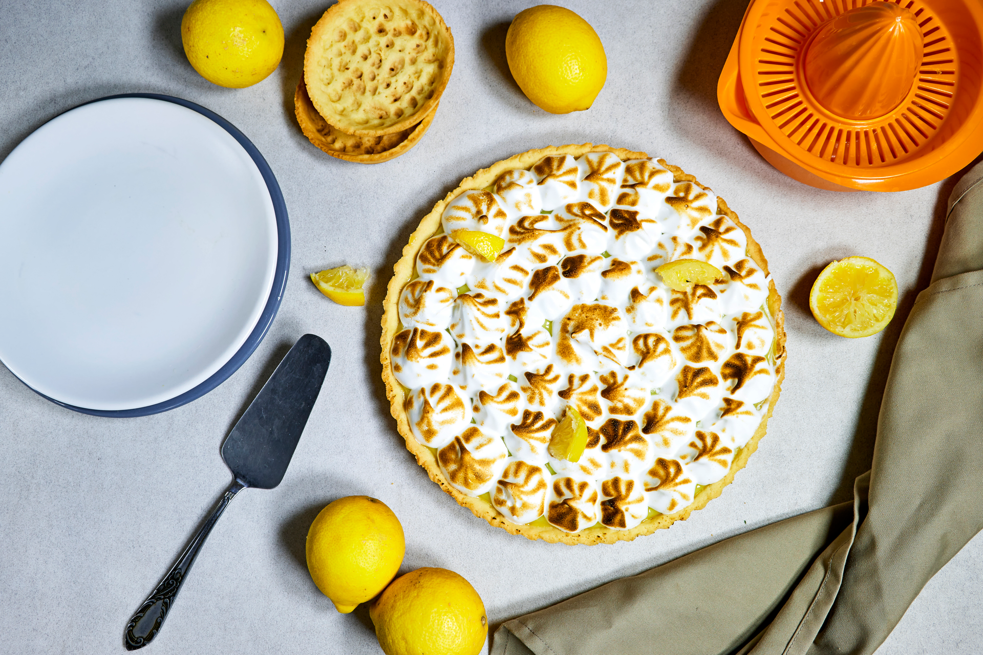 Overhead flat-lay of all ingredients for Portuguese Almond Torta de Azeitão with Lemon Zest laid out on a kitchen surface.