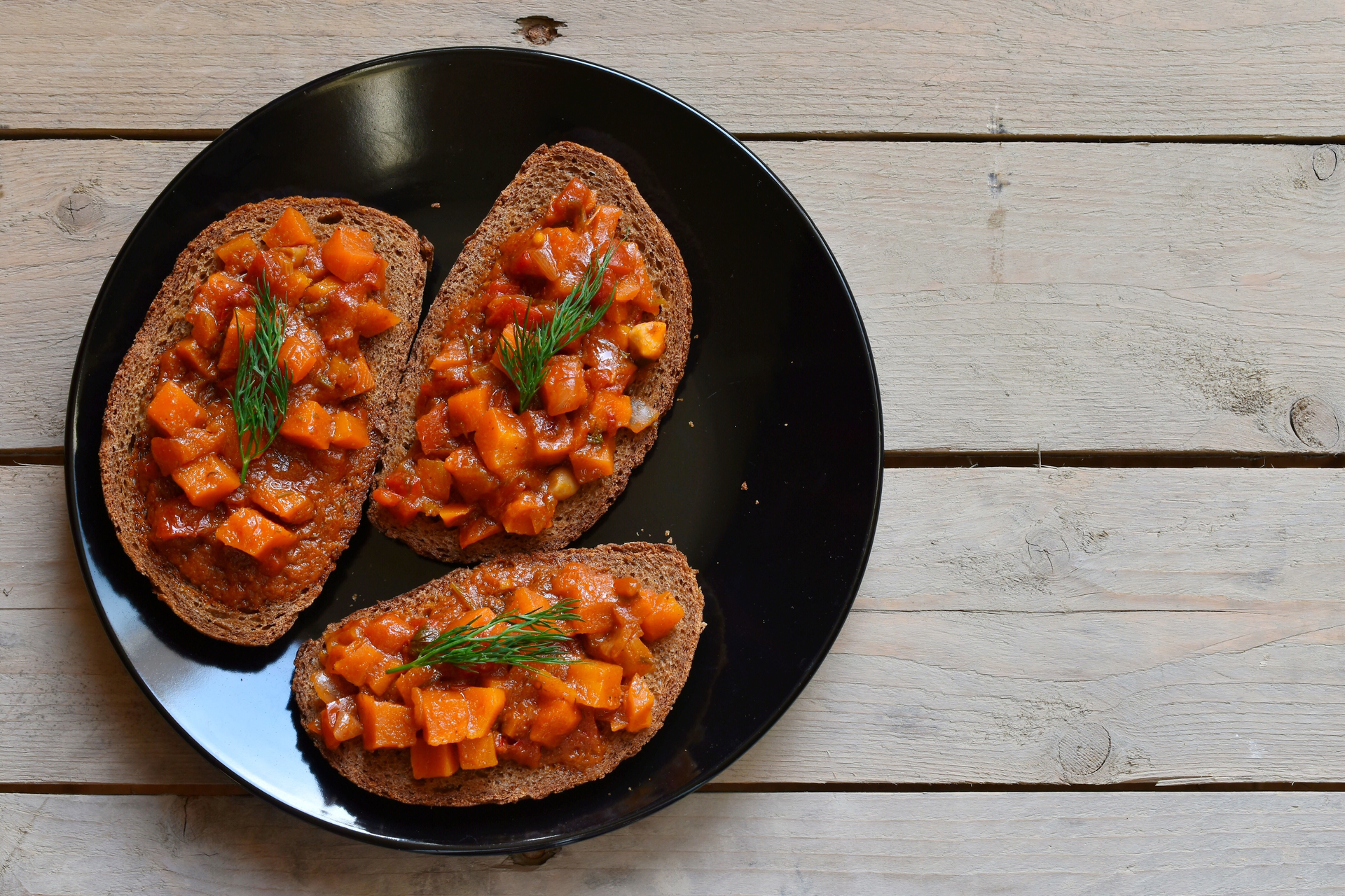 Overhead flat-lay of all ingredients for Portuguese Bean and Chorizo Stew with Garlic Toast laid out on a kitchen surface.